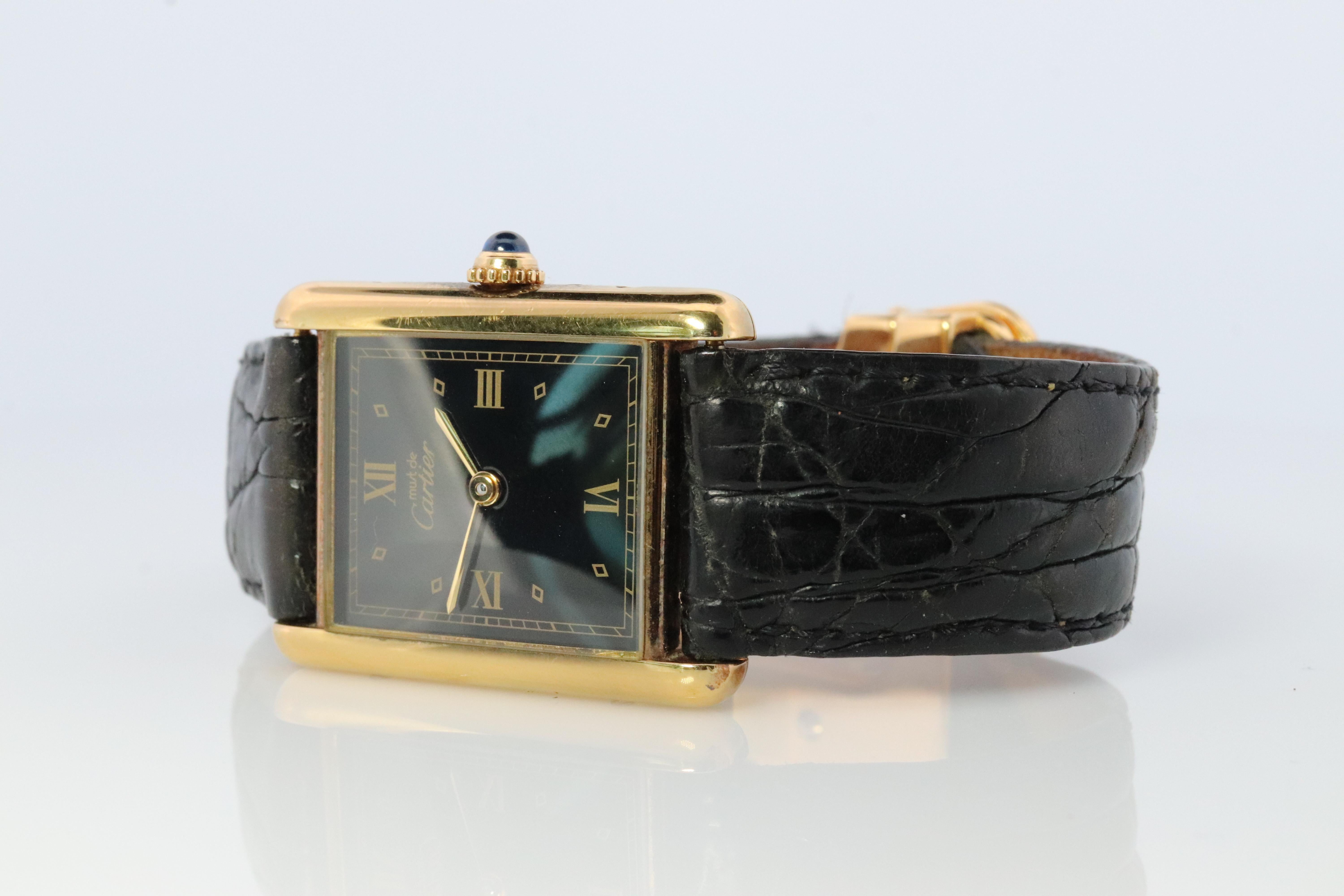 Genuine Cartier watch. Vintage Iconic Tank Argent. Sterling Silver and Gold plated (Vermeil). Comes with original Cartier band with clasp.

Rare Jet Black dial.

QUARTZ

Condition: Has some discoloration on the sides that is consistent with age. New
