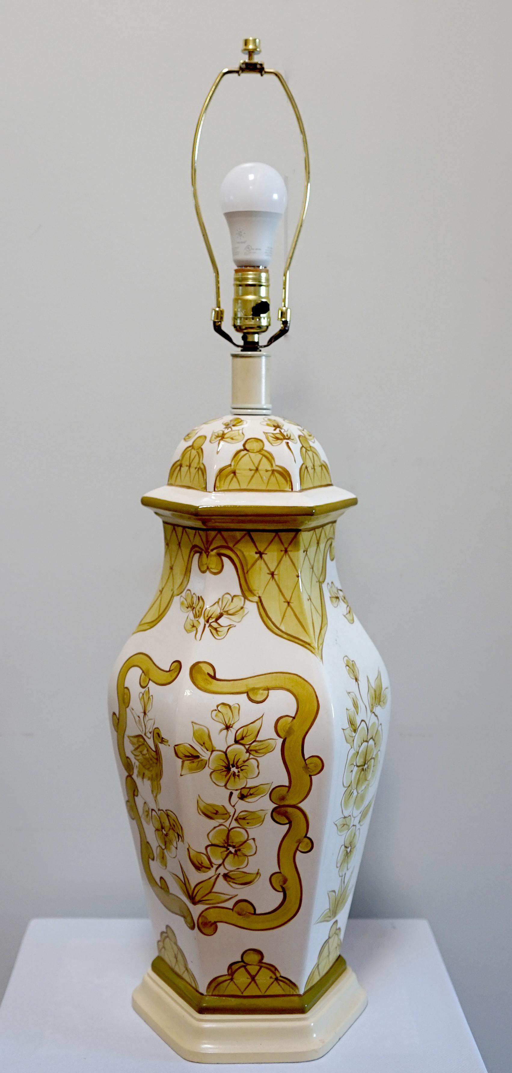 The shape and the Moorish or colonial theme in mustard yellow make this lamp a classic standout on a white background. The lamp is intact without condition issues. The hexagon shape is architectural and the lamp makes a dramatic statement with its