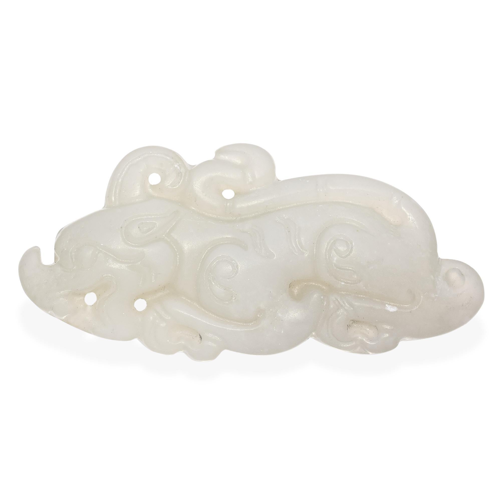 Expertly carved from highly prized mutton fat white jade, this vintage piece depicts a stylized dragon in a reclining pose, featuring intricate swirling details and pierced accents. The smooth, creamy translucence of the jade enhances the mythical