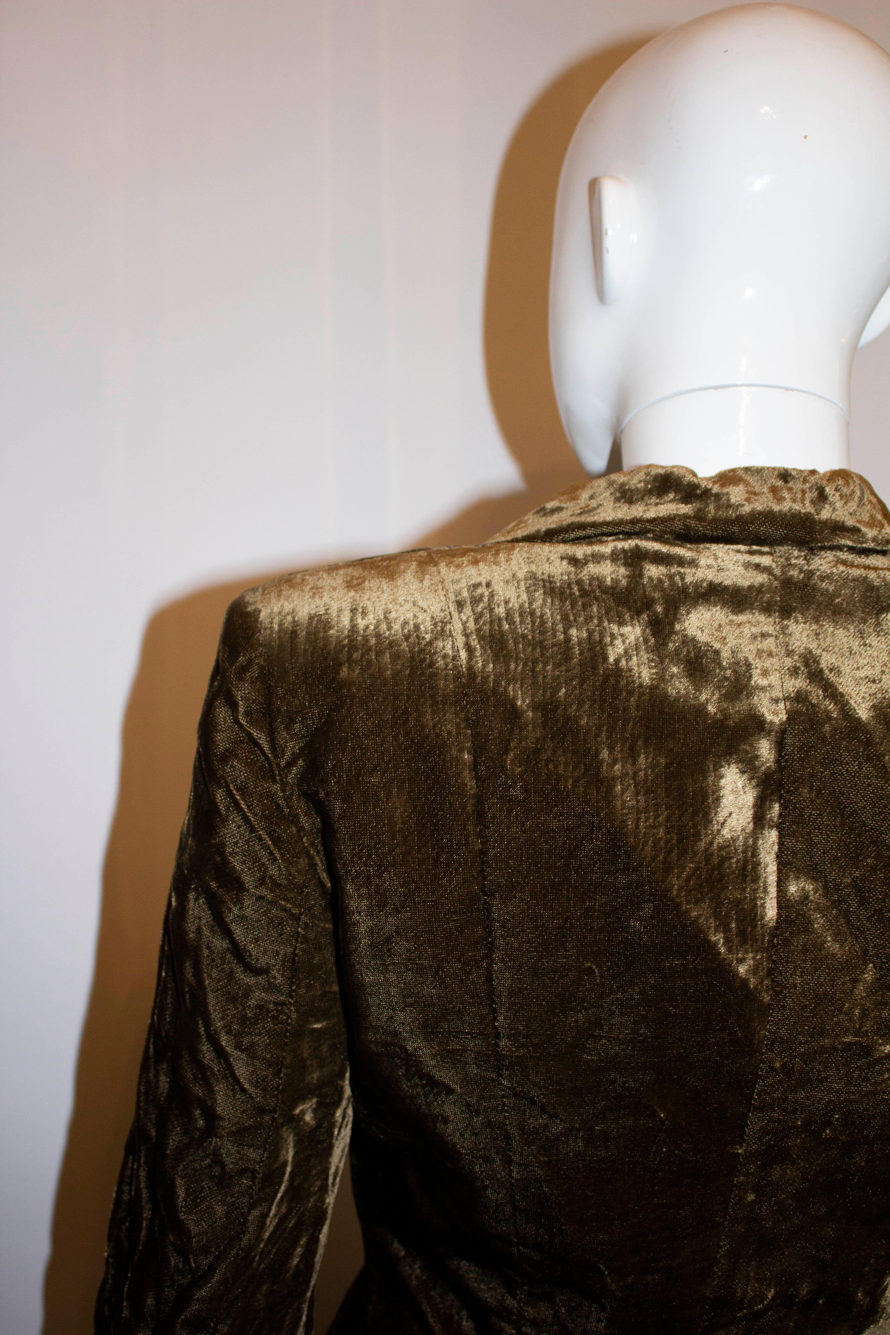 A super chic and soft vintage velvet jacket by Myreene de Premonville. In an olive brown colour with mother of pearl buttons, the jacket has a cut away collar ,interesting cuff detail and is fully lined. There is enough space to move the buttons 1''