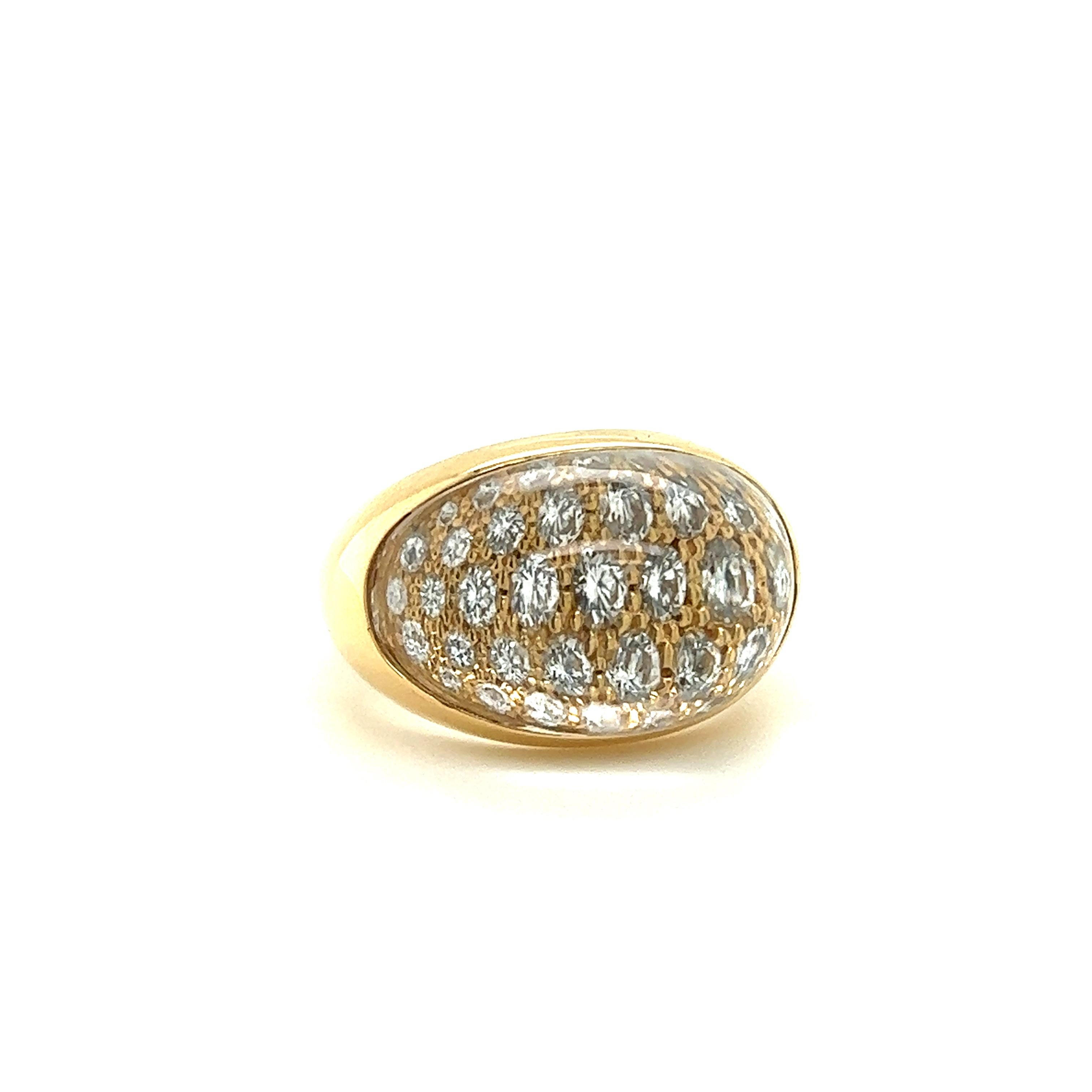 One elegant ring crafted by famed designer Cartier. The ring is from the Myst De Cartier collection, and is crafted in 18k yellow gold. The ring is a unique design as it highlights round brilliant cut diamonds that are set with a cabochon cut quartz