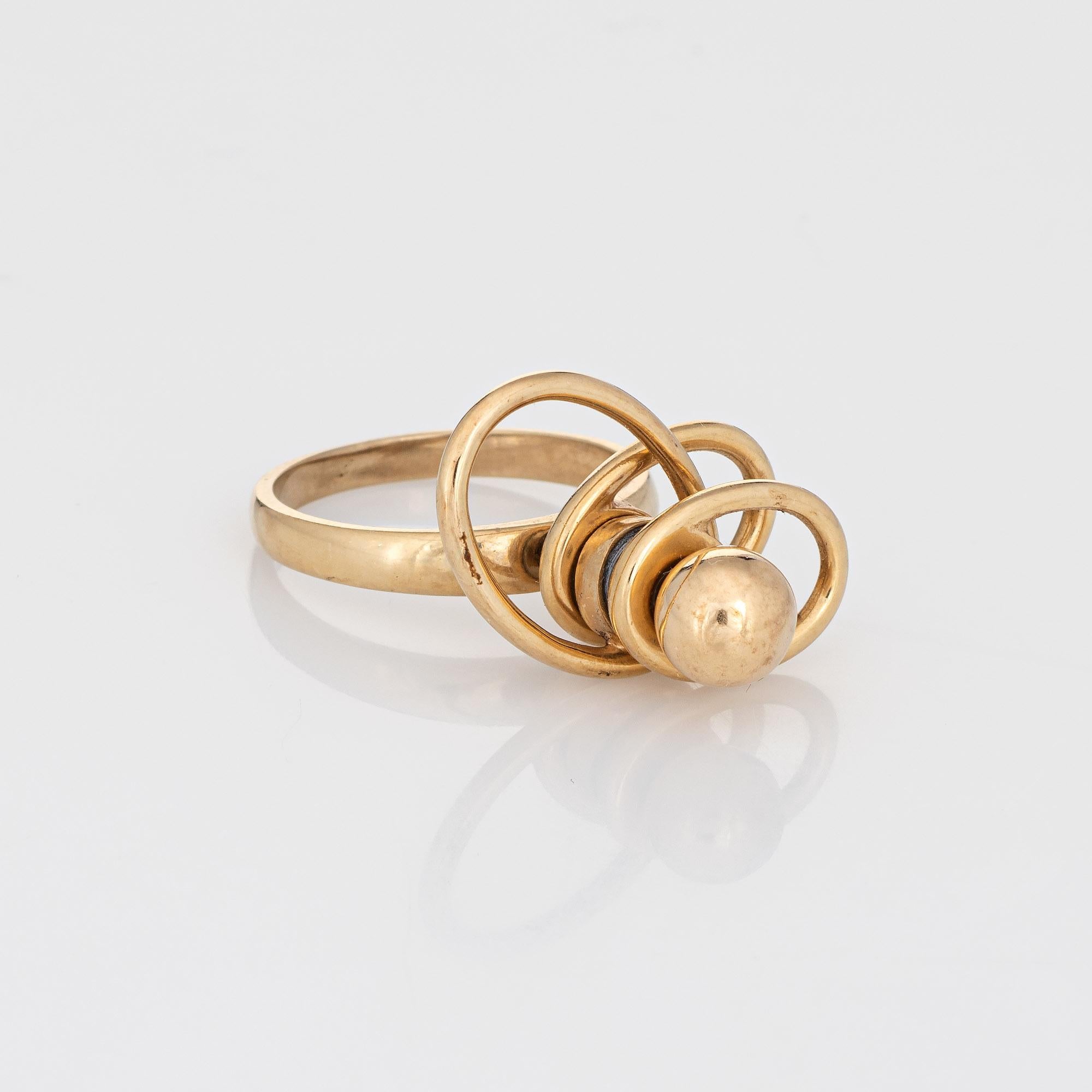 Finely detailed vintage N Teufel spinning ring (circa 1975), crafted in 14 karat yellow gold. 

In 1971 Norman Teufel created the 'swinger' ring. Stainless steel ball bearings in combination with fine jewelry components such as 18 & 14 karat gold