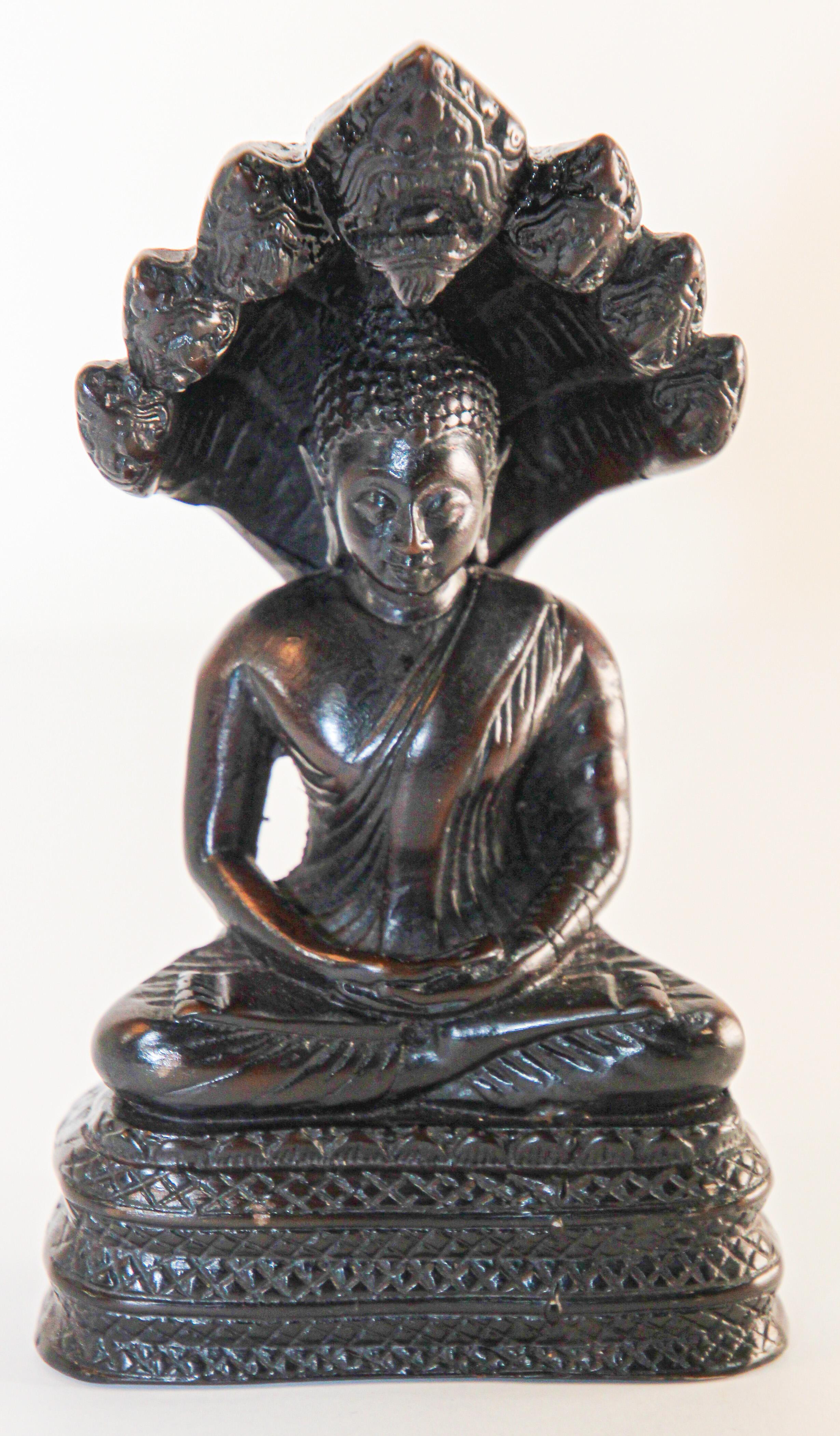 Vintage Naga Meditating Buddha Statue.
In Buddhism and Hinduism, Naga is the Sanskrit word for a deity taking the form of a very large snake, specifically the king cobra with multiple heads.
Vintage Mid century Hindu art of a peaceful Naga