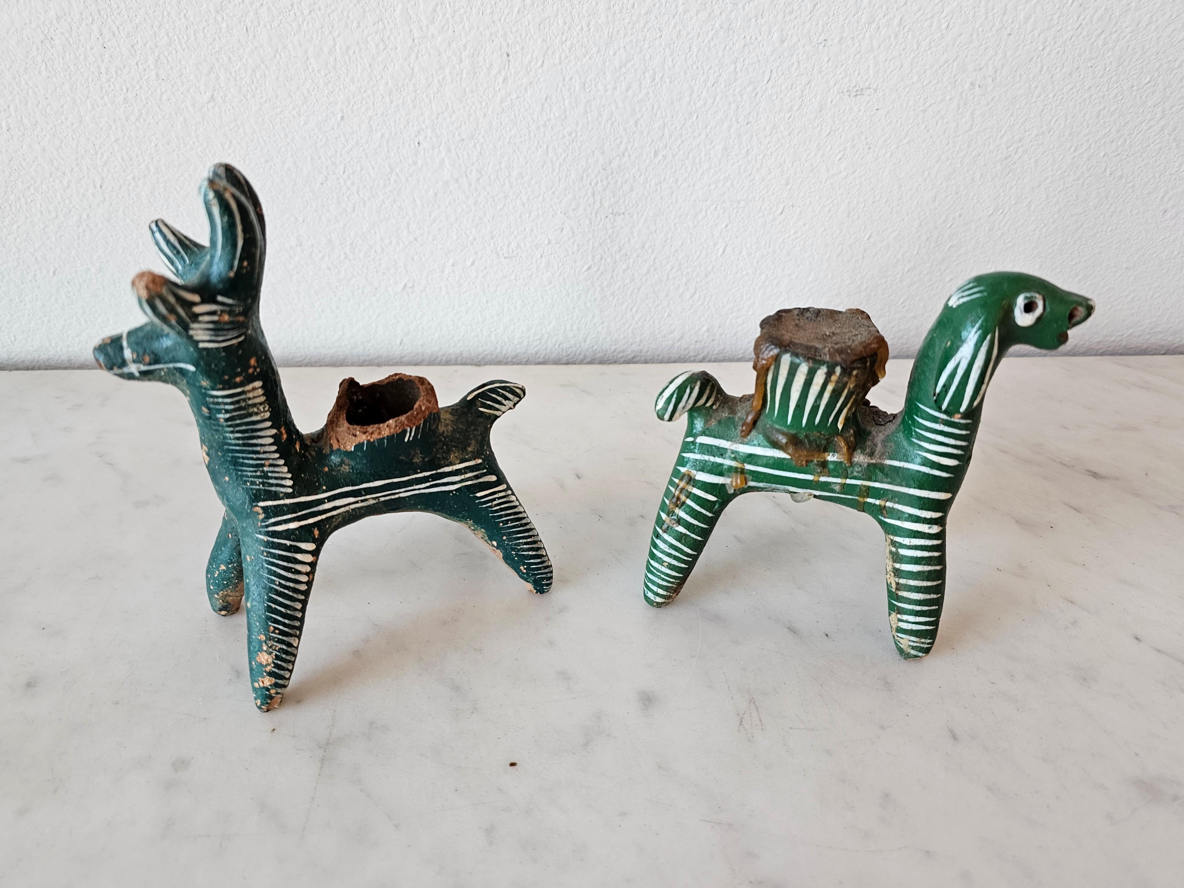A most charming pair of two rare and whimsical indigenous Nahua peoples pottery animal folk art candleholders.

Handmade in the village of Chililico, Hidalgo, Central Mexico, primitive lightly fired earthenware, figural sculptural form, depicting a