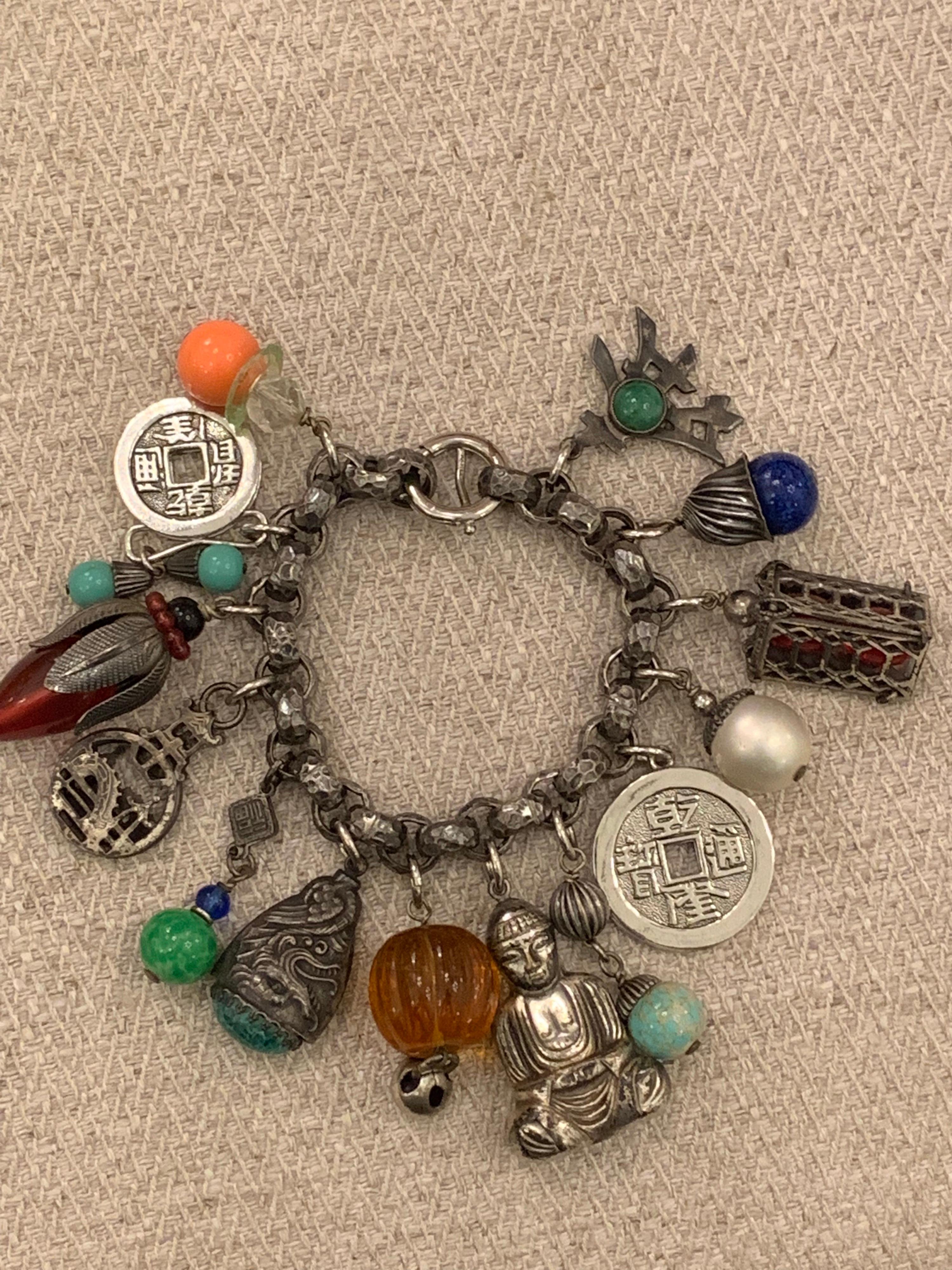 Chunky charm bracelet by Napier - truly a runway showstopper! Asian themed charms...buddhas, lanterns, coins and symbols mixed with multi colored pate de verre drops. SIGNED on clasp - Circa 1950's. 8