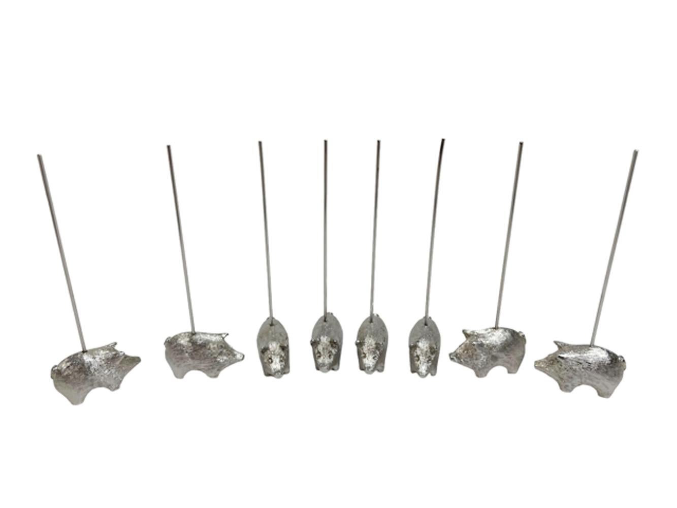 Set of eight appetizer picks in the form of piglets supporting metal skewers for serving individual hors d' oeuvres. The set is still in its original box. 