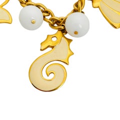 Bracciale vintage NAPIER con smalto dorato e catena a maglie con ciondoli marini