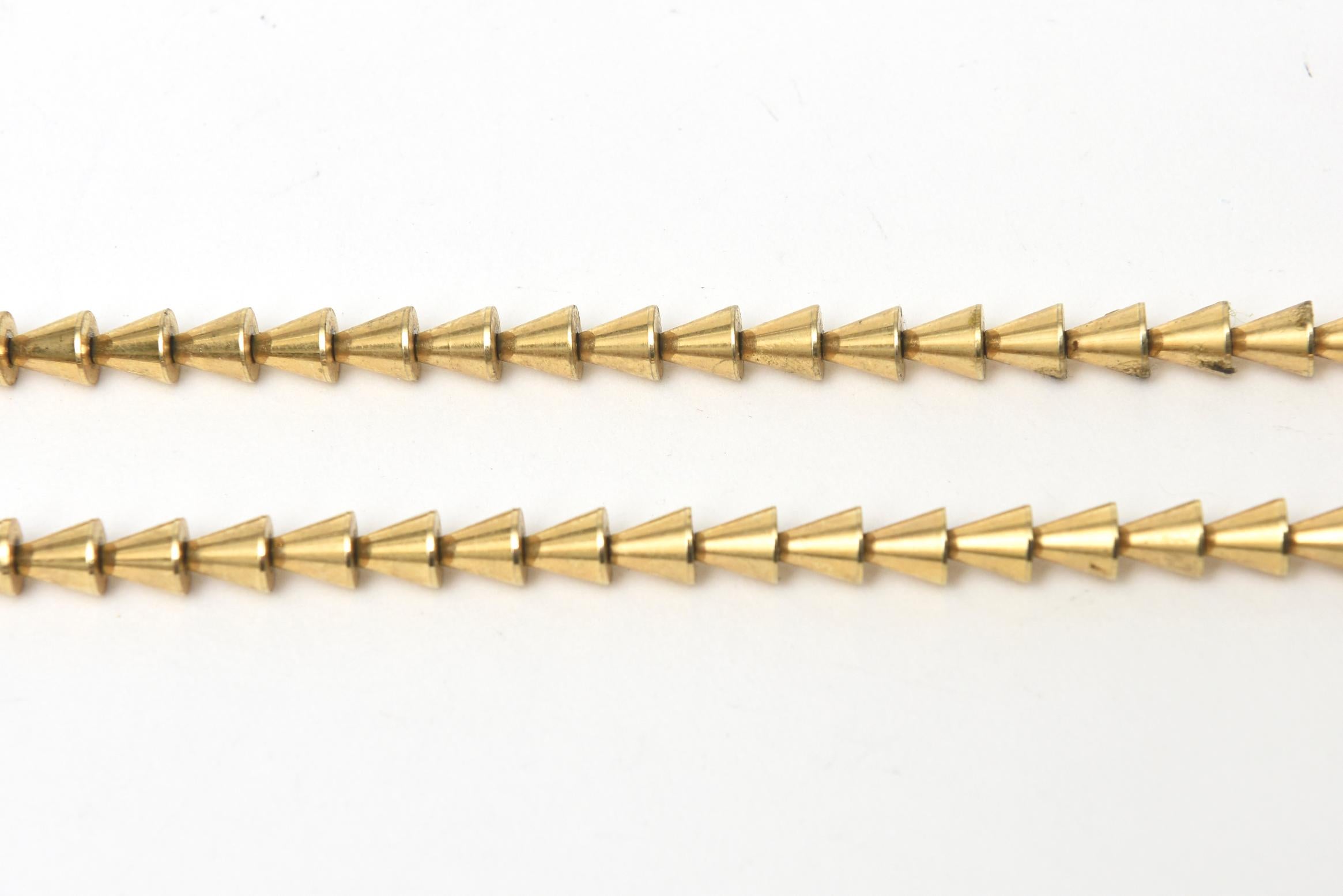 This very chic and au courant signed vintage Napier long necklace has reticulated triangles as the geometric pattern. It can be doubled up. It is on a slide chain. It is as modern today as was from the time period. This is from the 70's. 

