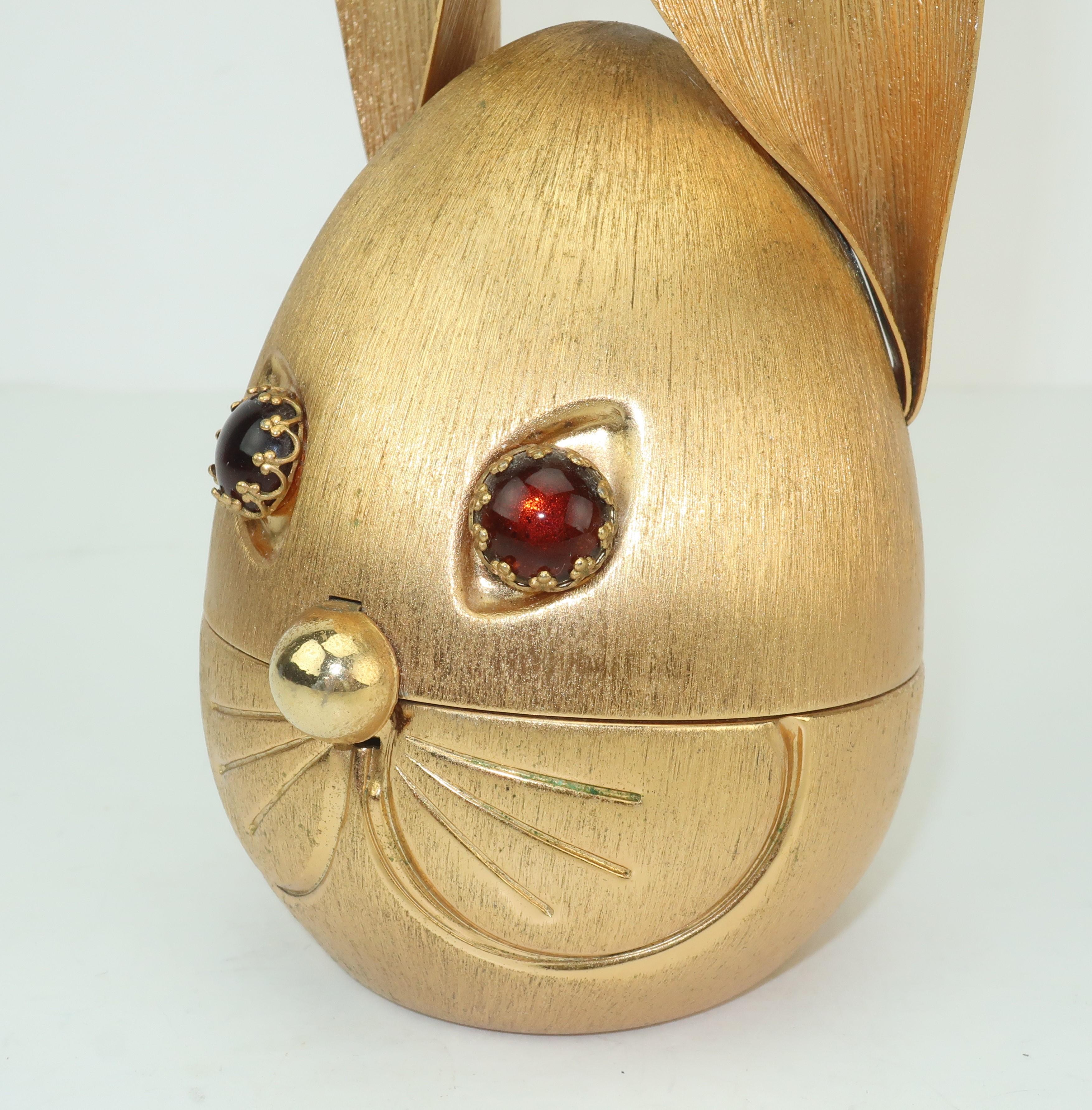 It's a bunny banker! This brushed gold tone rabbit bank by Napier is a great whimsical accessory for catching all your coins. His amber glass eyes and dome nose provide dimension and a bit of animation while the hidden screw in the back allows easy