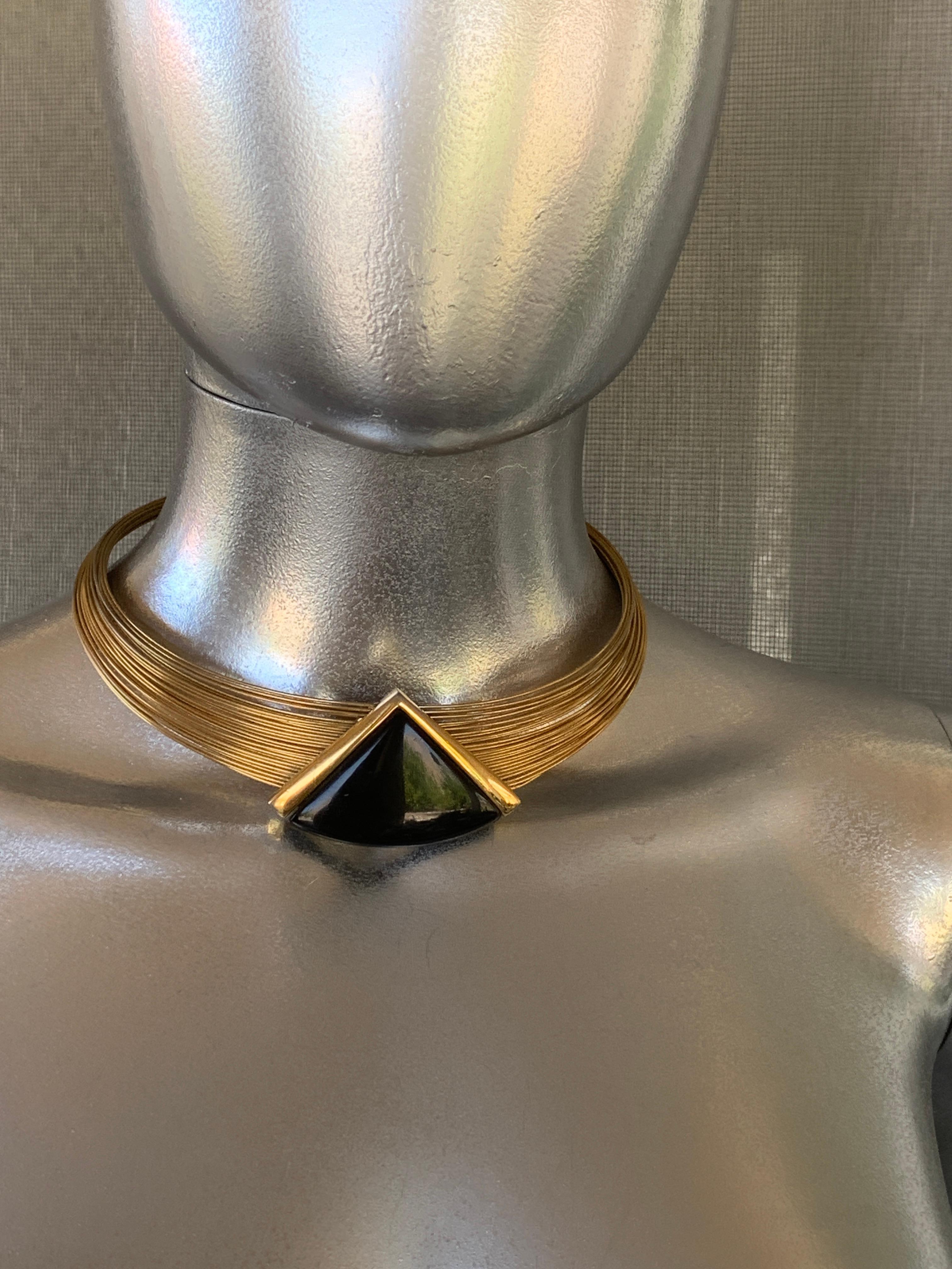 Just so modern! Napier designed some Modernist jewelry that is highly collectible and desired by many collectors. This 1980s beauty is a modernist choker that looks like gold wire. The gold plated wire is firm and easily held around the neck. The