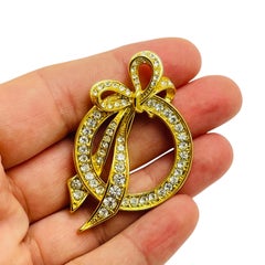 Vintage NOLAN MILLER signed gold tone rhinestone bow designer brooch