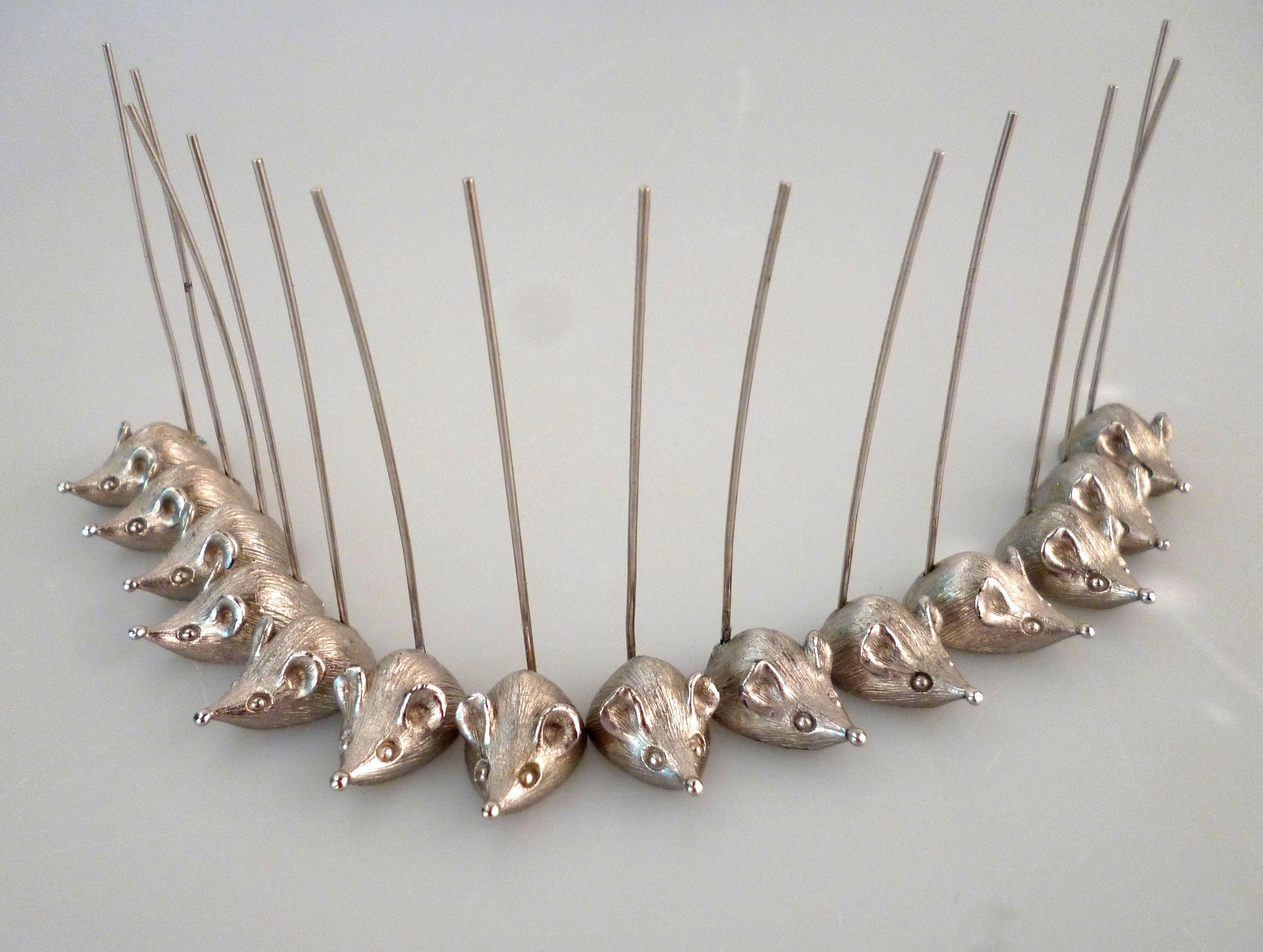 Charming Mid-Century Modern set of fourteen silver metal mice with long tails for skewering cheese or other small appetizers.
Individual Servers for cheese or hors d'oeuvres by Napier.
All are marked on undersides.
What a joyful presentation for