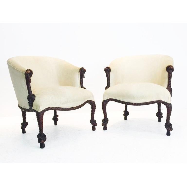 Beautiful pair of carved rope and tassel Napoleon III style painted armchairs. Features a solid carved wood barrel back stained wood frame, Luxurious velvet upholstery. Price is for the pair.

The illusion of twisted and knotted rope is often