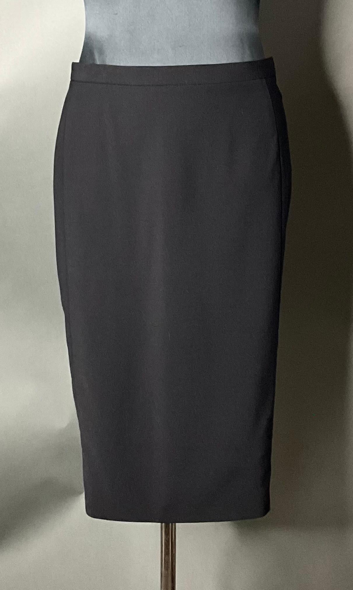 The Vintage Narciso Rodriguez Black Wool Skirt is a timeless and elegant piece that epitomizes the designer's signature minimalist aesthetic. Made from luxurious wood, it offers a smooth, sophisticated drape and an understated silhouette. Despite