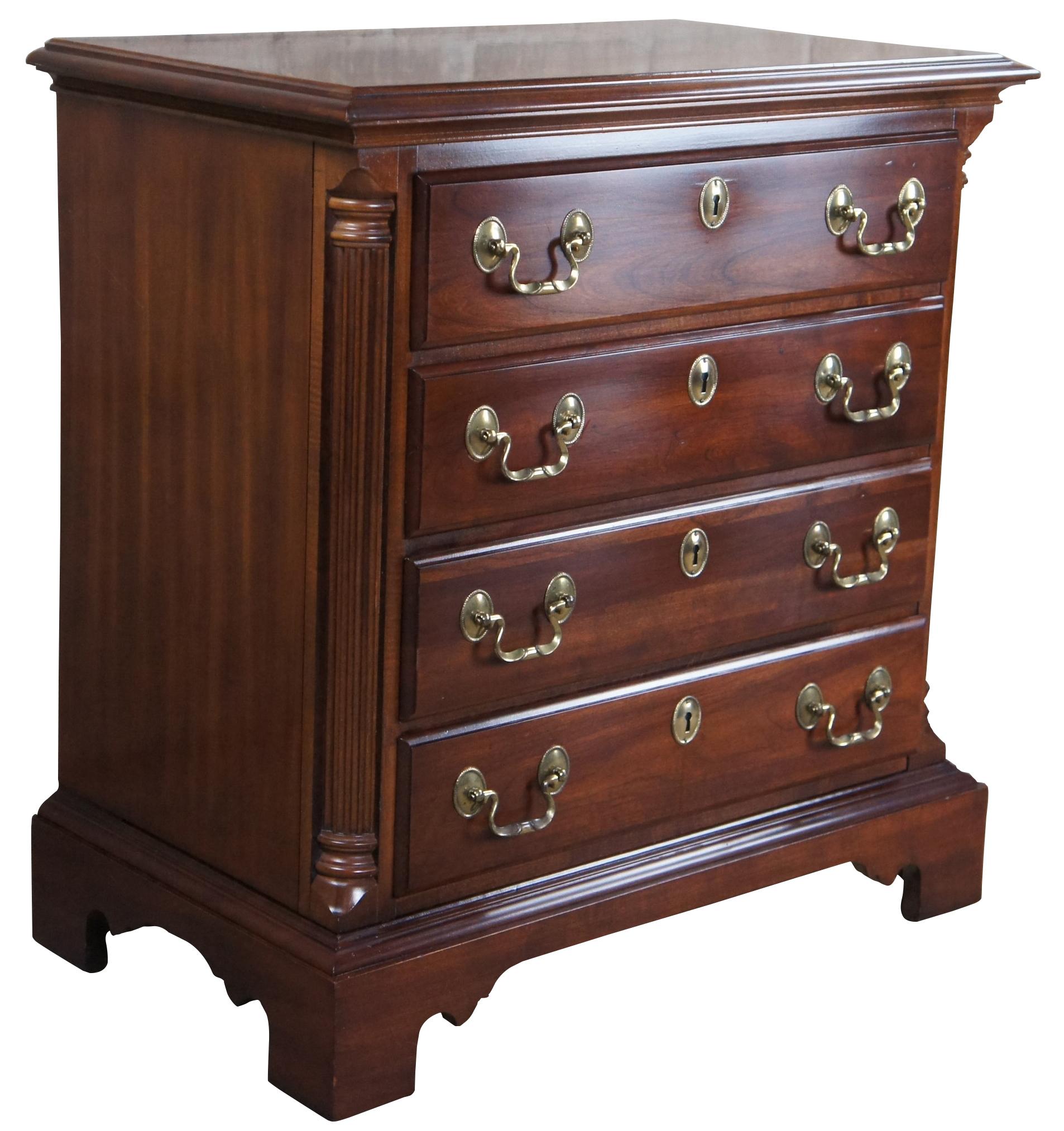 Vintage National Mt. Airy four drawer dimunitive chest, nightstand or side table, circa last quarter 20th century.  Made of cherry featuring rectangular form with quarter cut grecian fluted columns,  brass bail drawer pulls, and bracket feet.

