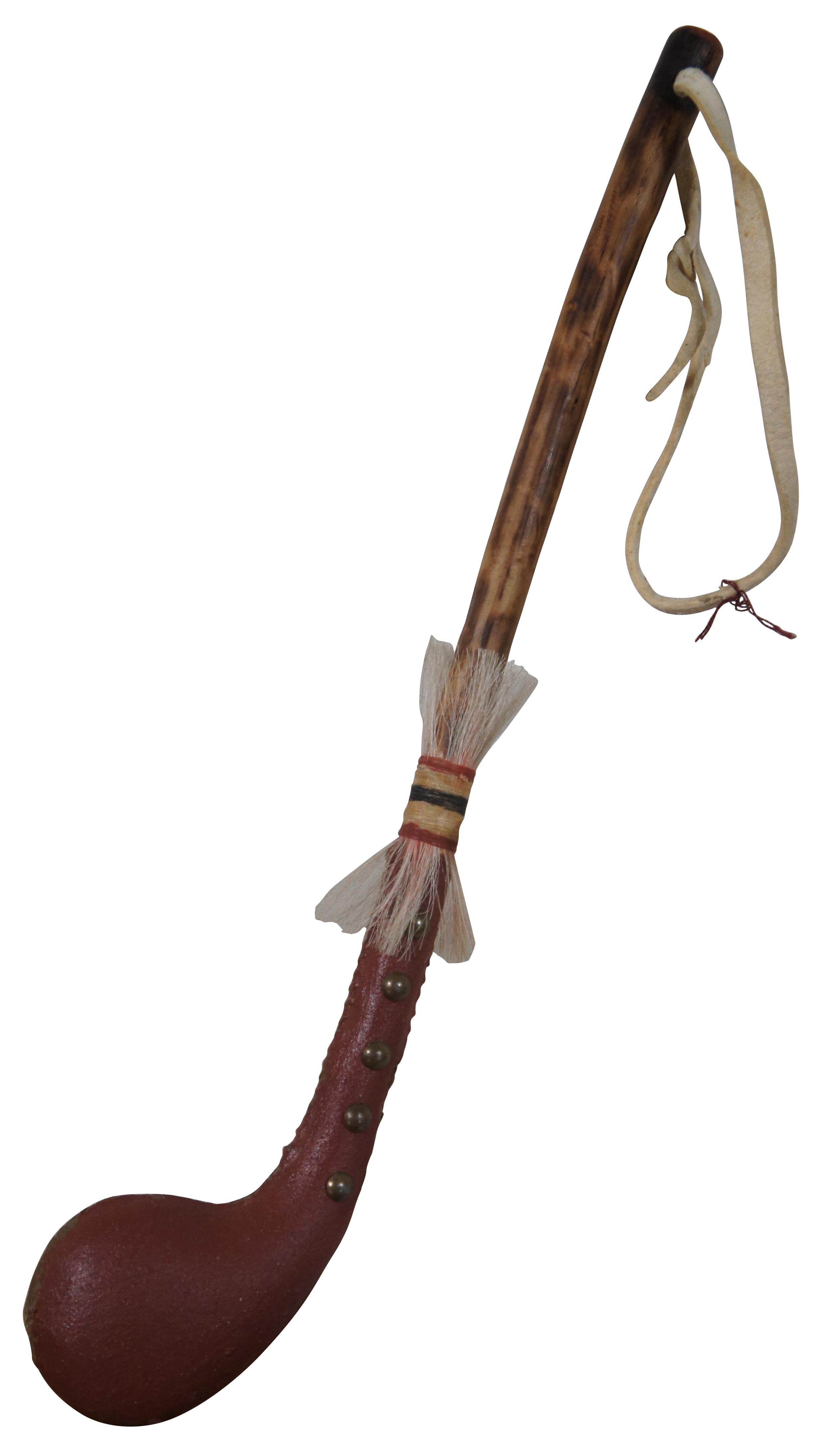 Vintage Native American ceremonial dance / war club tomahawk with heavy studded concrete / stone head painted in red with wood branch handle and decorated with wrapped horse hair.