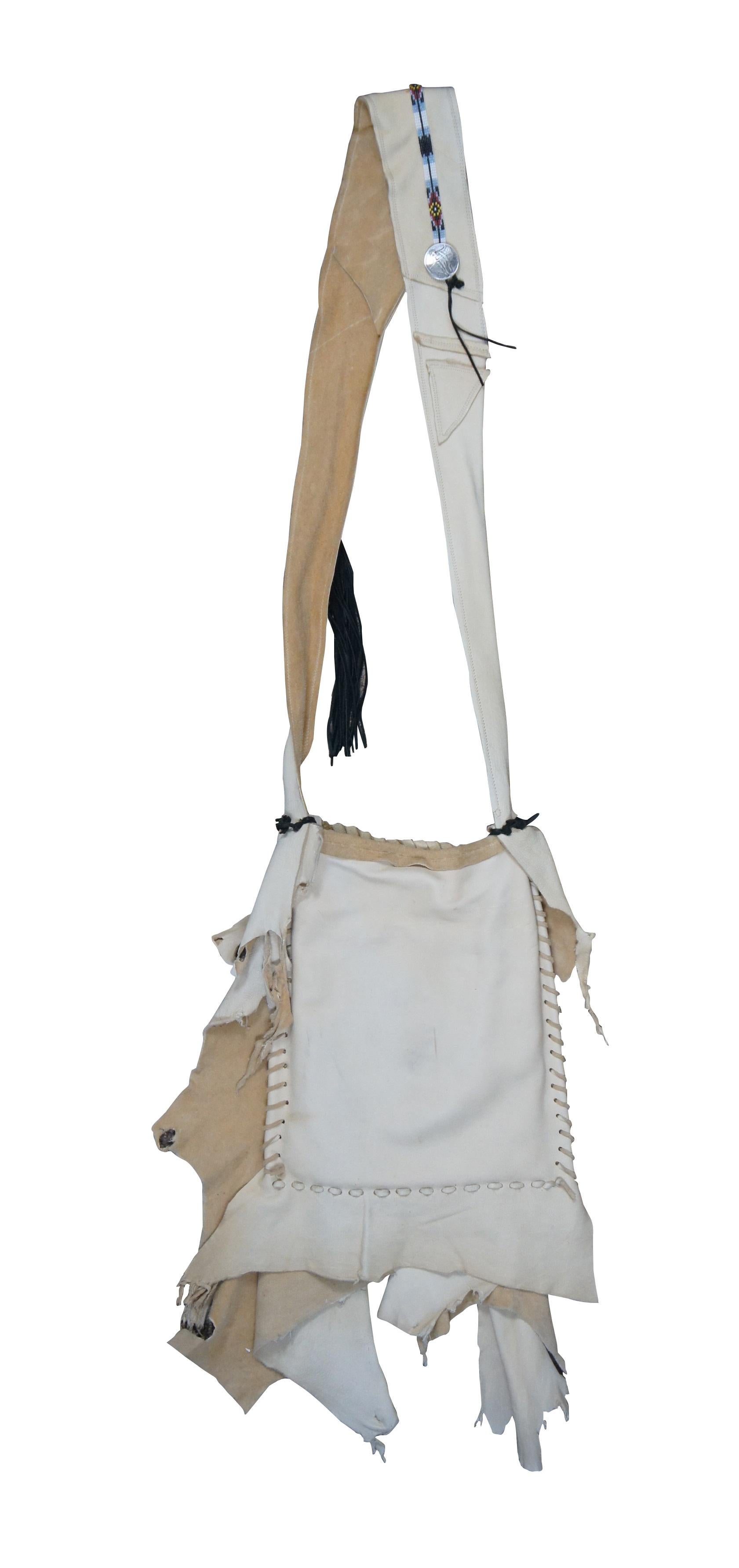 Late 20th century Native American style shoulder bag / purse / satchel. Made of soft asymmetrically cut off-white leather with decorative stitching, antique United States 1904 