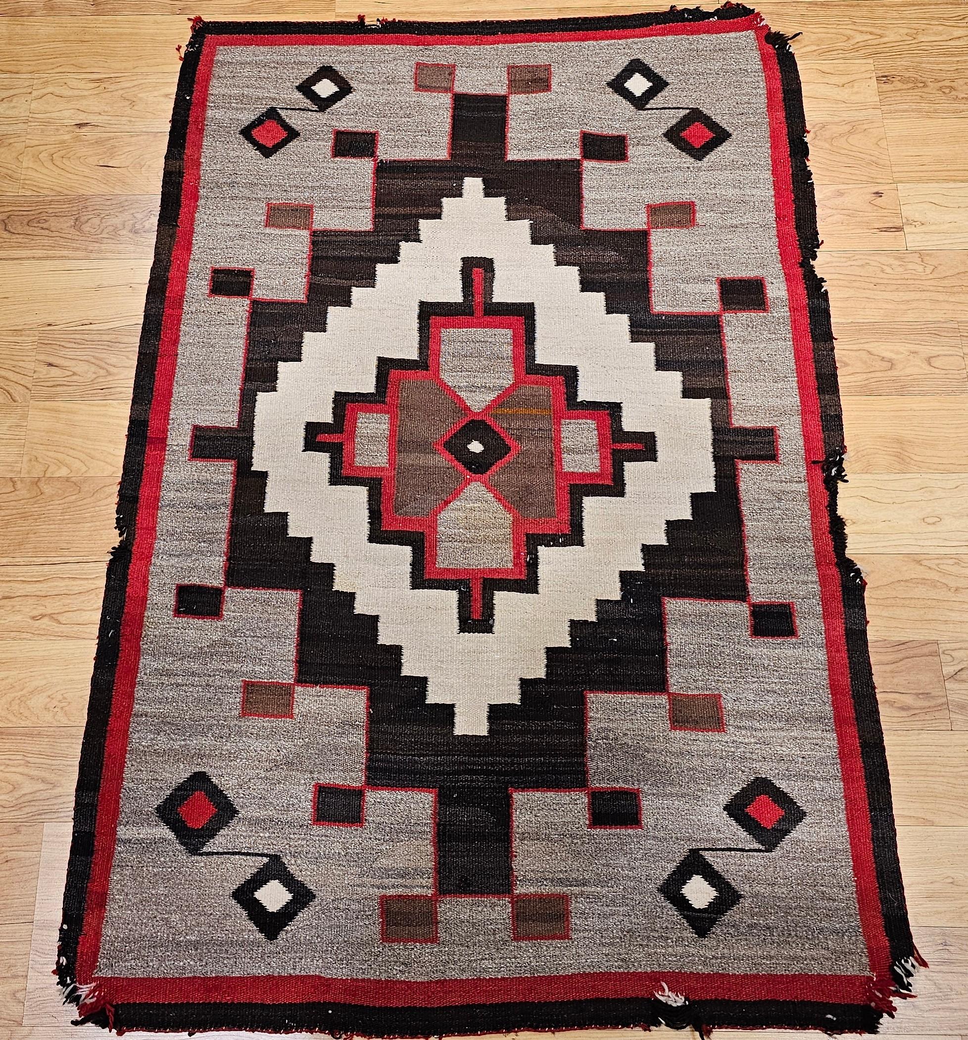 Finely hand-woven Native American Navajo Rug in wheat, red, brown, and oatmeal colors from the SW United States from the early 1900s.  This Navajo rug is in a geometric pattern consisting of a large medallion set in beautiful natural organic dye