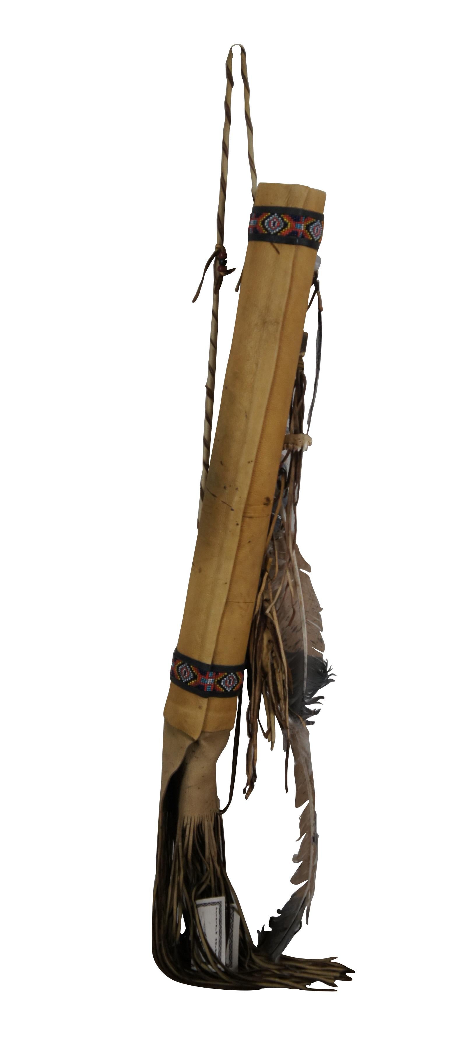 Late 20th century Native American deerskin leather quiver. Beaded bands around top and base, soft leather fringe at bottom, decorated with feathers, beads, several pieces of animal bone, quartz prism, arrowhead and medicine bag. Crafted by Jannee