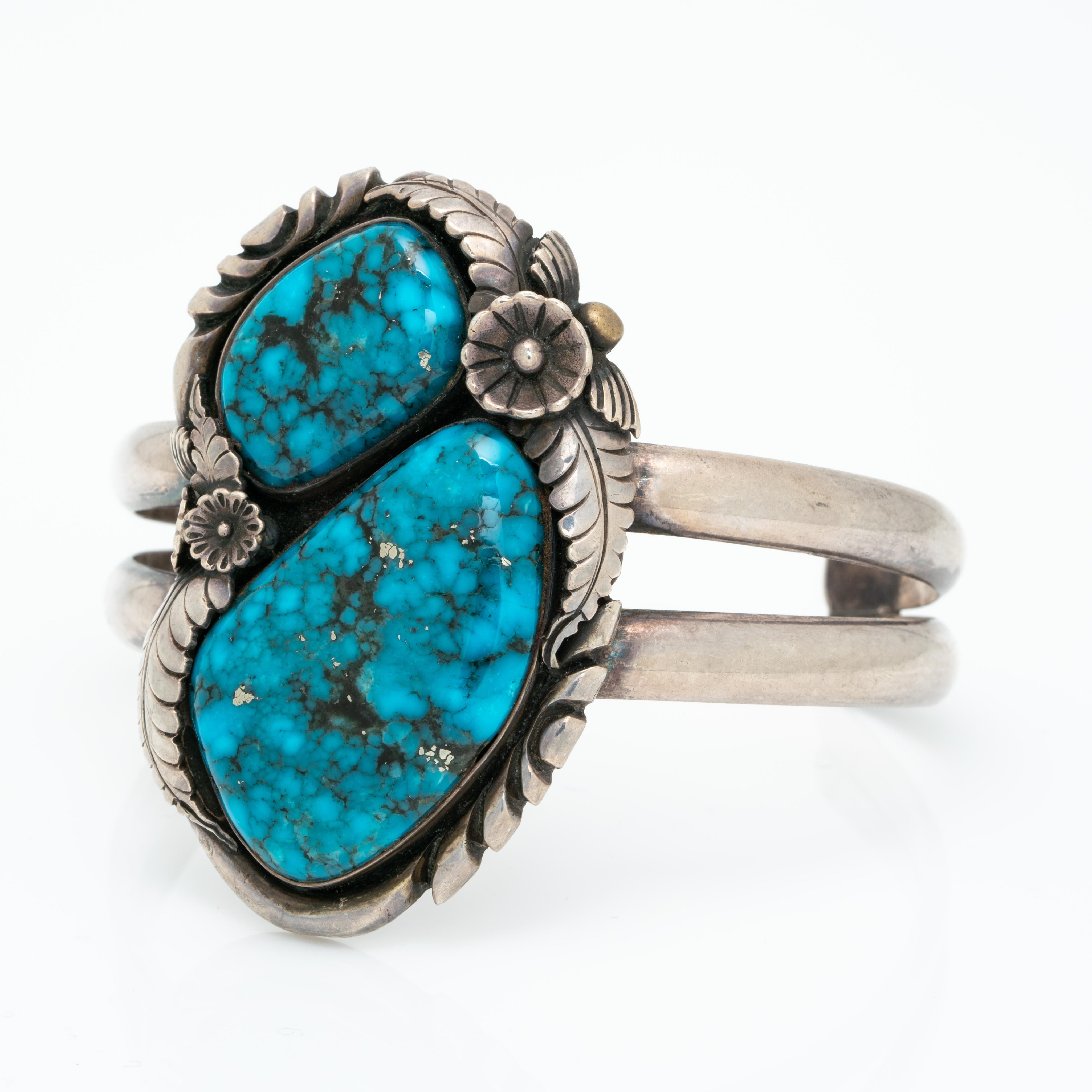 Vintage Native American Navajo Large Morenci Turquoise And Silver Cuff c. 1960s

Hand forged. A wonderful signed vintage Navajo cuff!

The patina of the silver is oxidized, we do not clean vintage and antique silver pieces as some clients prefer