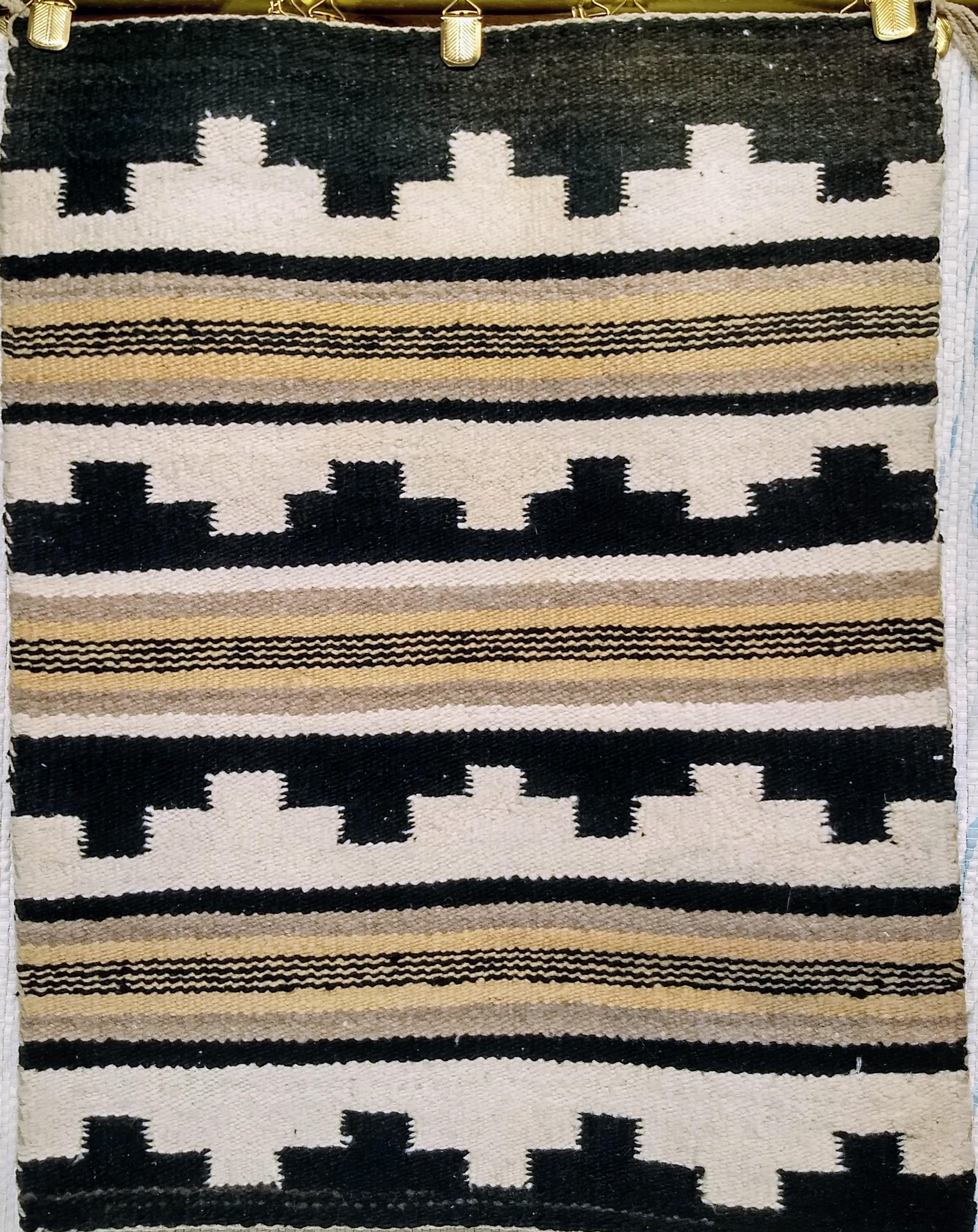 Beautiful vintage native American Navajo rug from the Southwest Area of the United States.  The Navajo rug has a striped pattern reminiscent of the Monument Valley in the Canyon de Chelly desert in the Southwest of United States in ivory, black, and