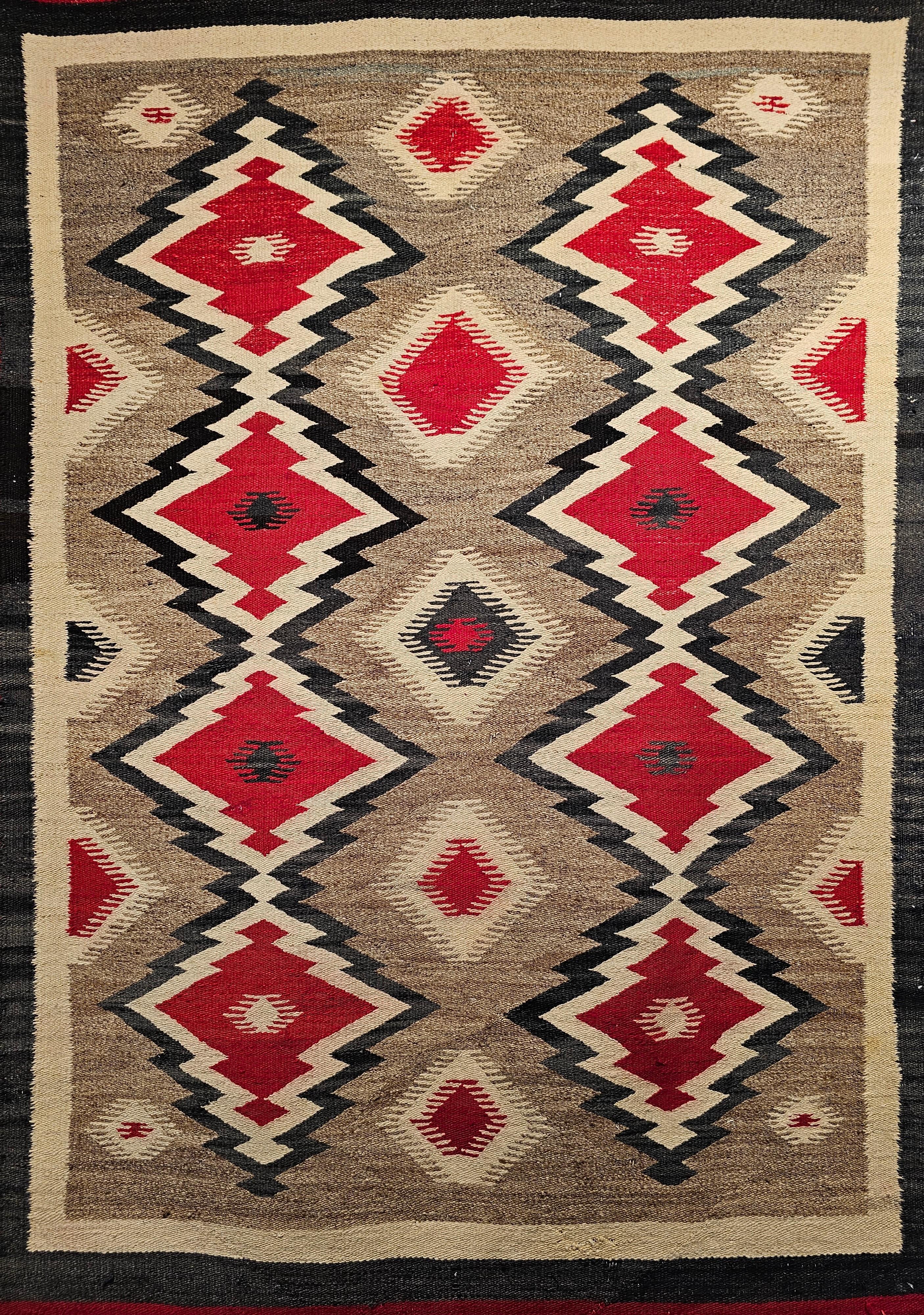  Feiner handgewebter Navajo-Teppich mit Eye Dazzler-Muster in Elfenbein, Rot und Schwarz aus dem Südwesten der Vereinigten Staaten aus den frühen 1900er Jahren.  Dieser Navajo-Teppich ist in einem geometrischen Design, bestehend aus zwei Spalten von
