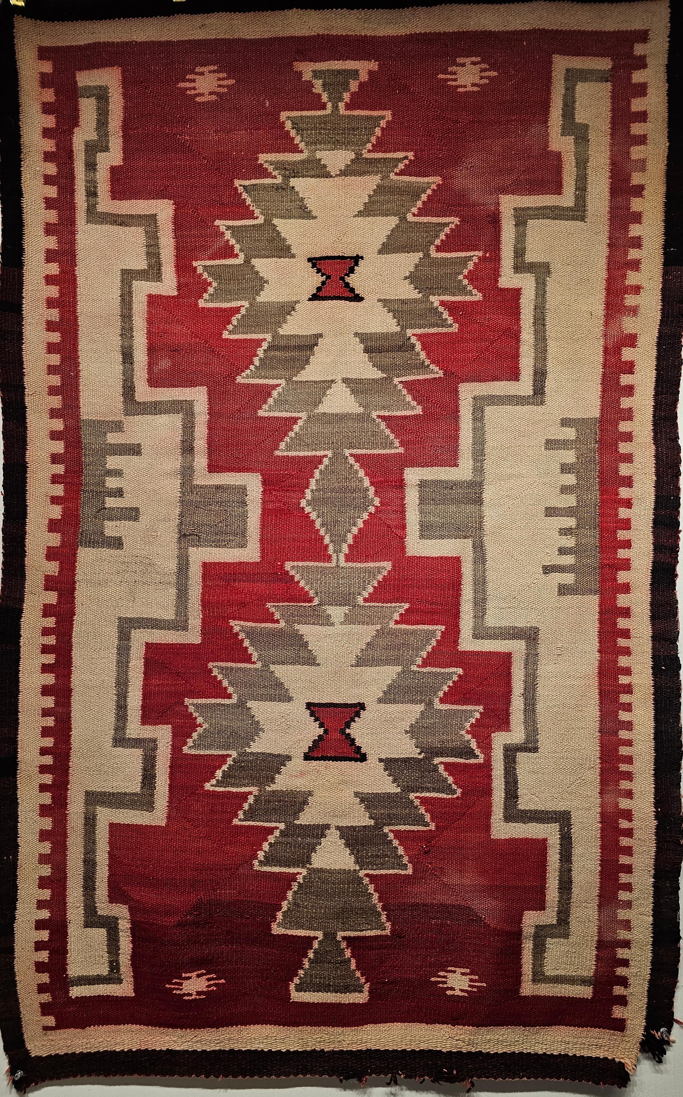 Vintage Native American Navajo Ganado Rug in Ivory, Pale Green, and Burgundy Color from the SW United States from the mid 1900s. Navajo rugs are generally flat woven with wool for the body of the rug and usually cotton foundation. Navajo weavers