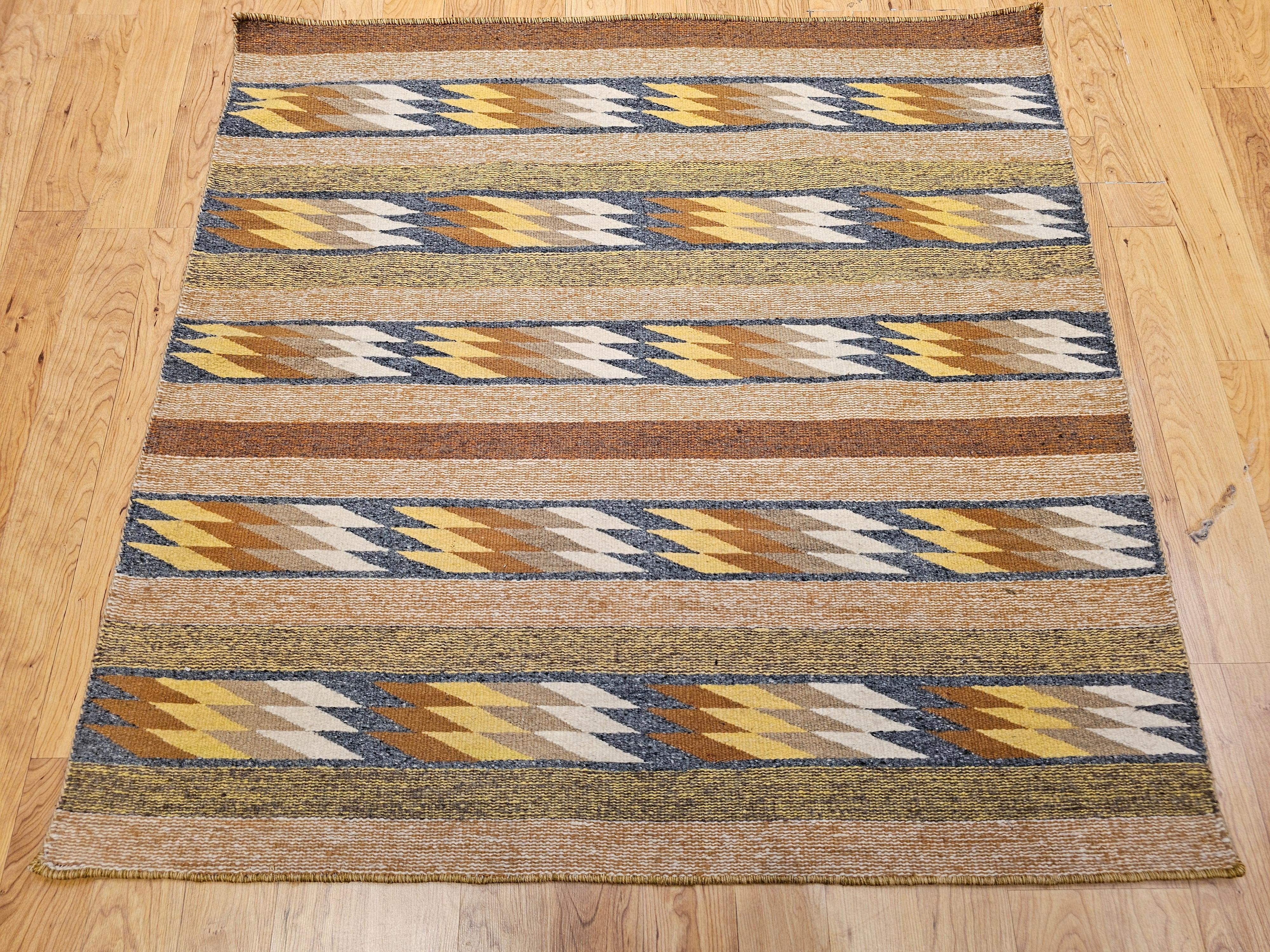 An exceptionally rare square-format Navajo rug, handwoven in the Southwestern United States during the third quarter of the 20th century, this vintage textile is a superb example of Native American weaving and Southwestern design heritage.
Its
