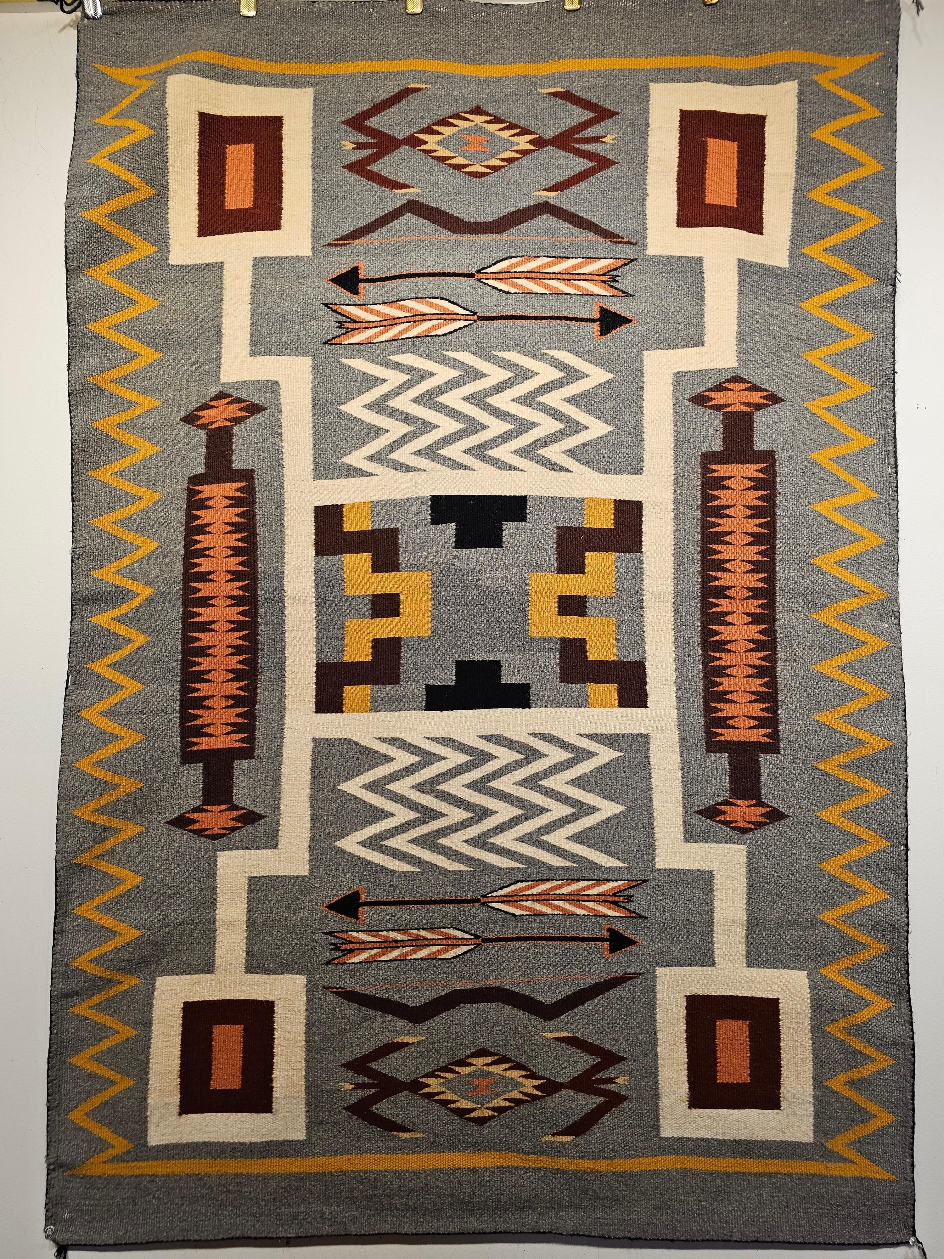 Vintage Native American Navajo rug in a Storm Warrior pattern in gray, brown, ivory, Pink, and Brown Colors.  The Navajo rug was hand-woven in the SW United States by Geraldine Johnson the matriarch of the famous Johnson weaving clan circa the
