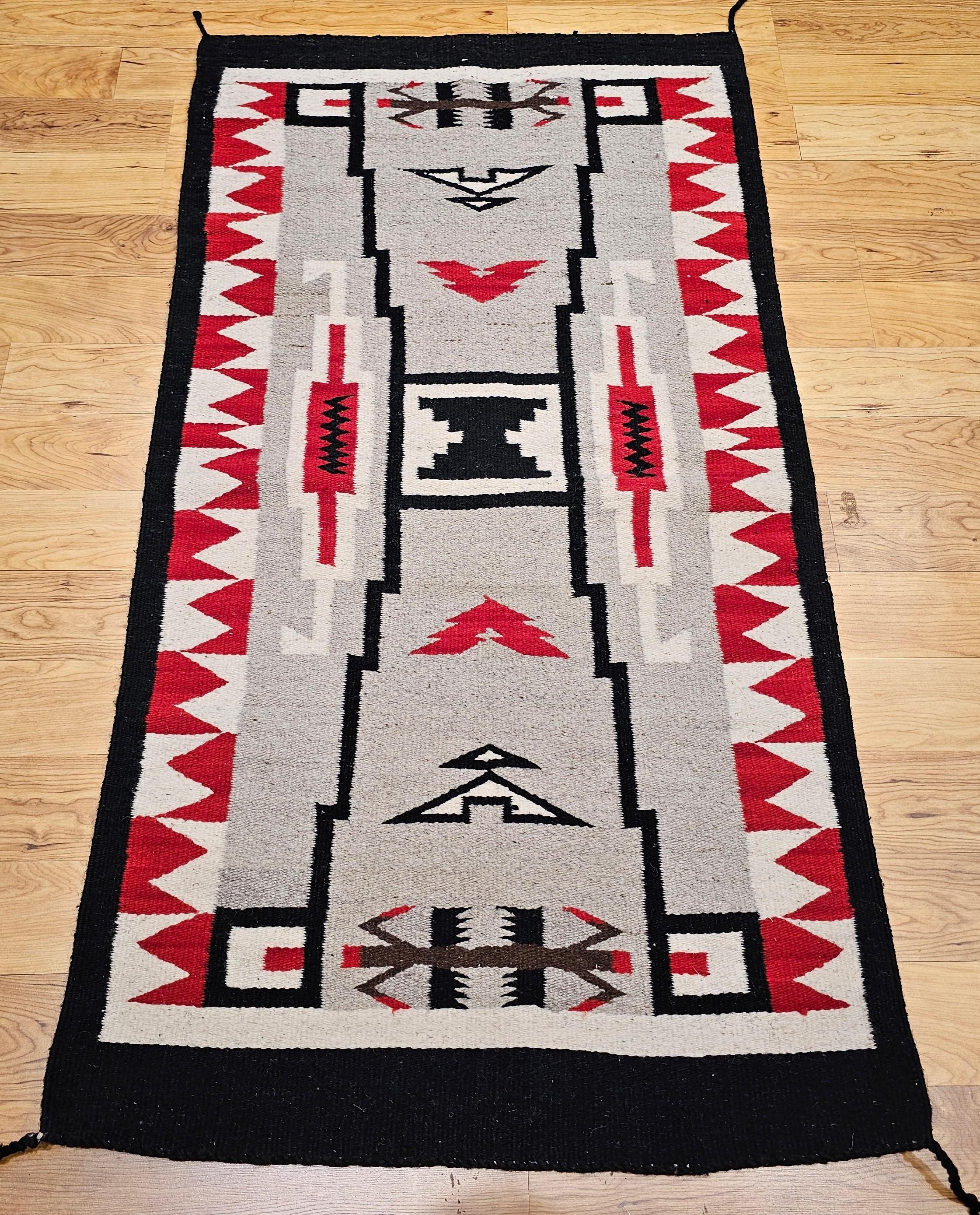 Discover the beauty and craftsmanship of this authentic vintage Navajo rug, handwoven in the Southwestern United States during the mid-20th century. Featuring the iconic Storm Warrior pattern, this exquisite piece showcases a rare and striking color