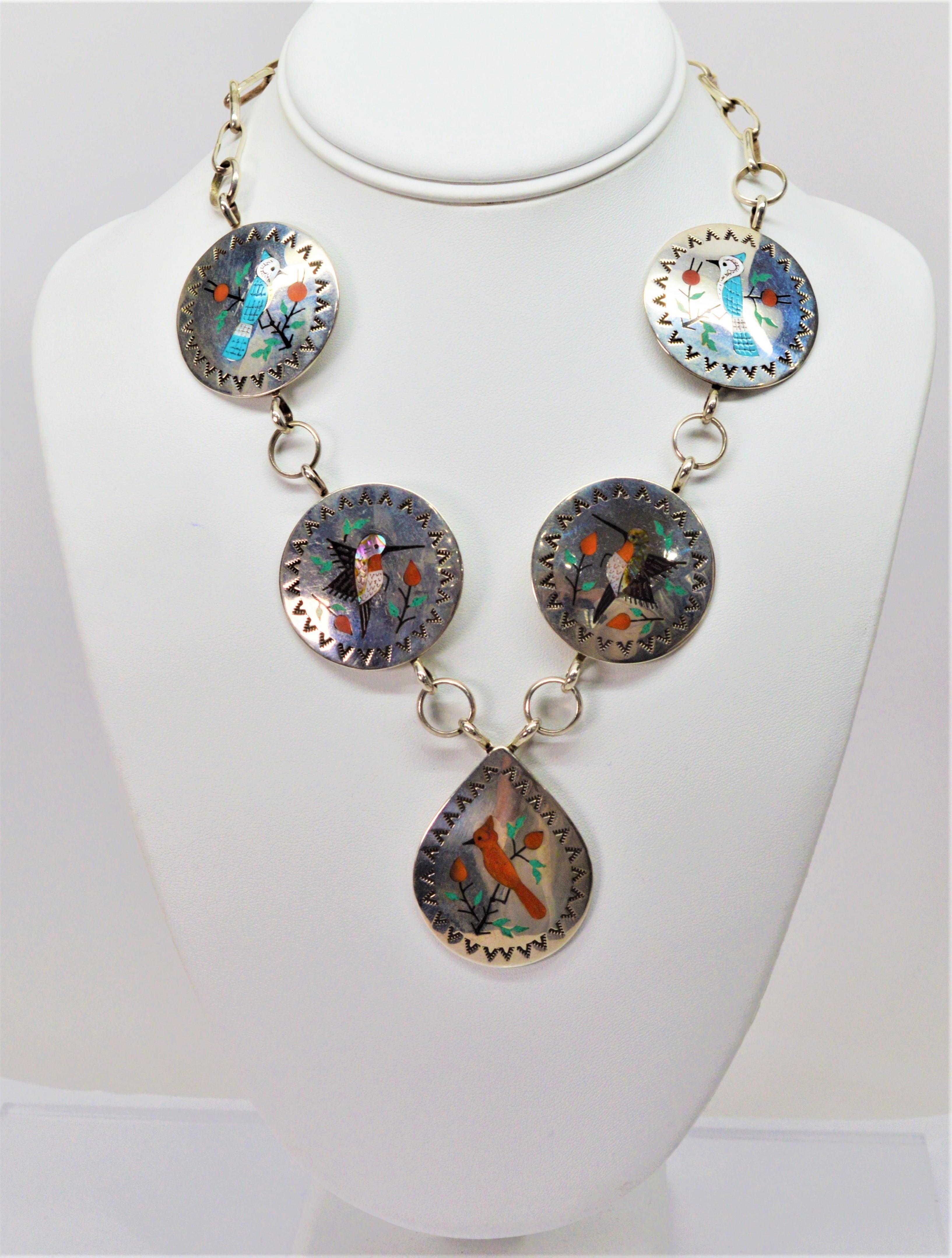 Raymond Boyd is a gifted and well respected Navajo silversmith specializing in Zuni style jewelry, especially in intricate bird inlay.  This handmade, signed necklace made in the 1960's is comprised of five sterling silver discs each displaying a