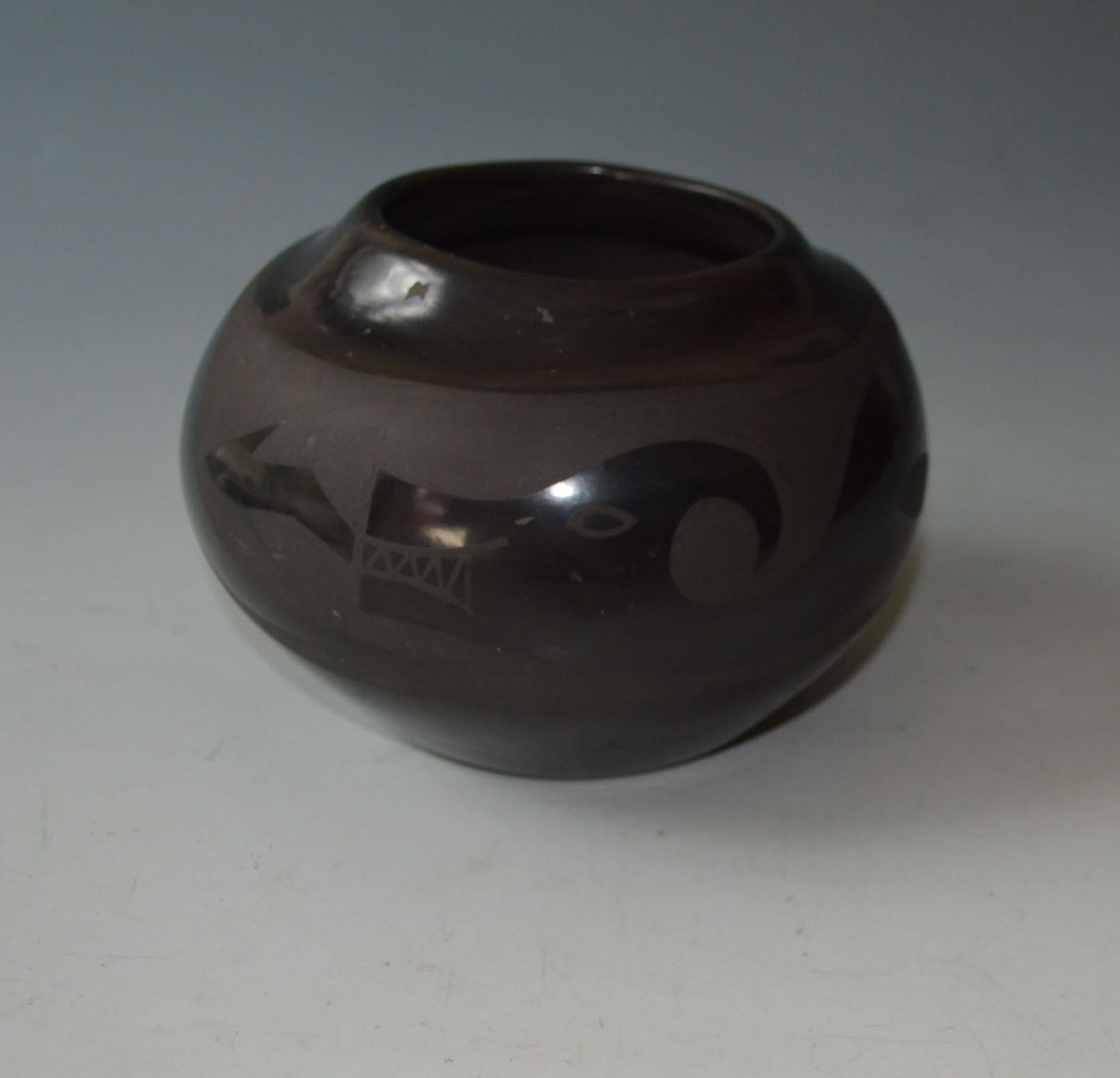 Fine Native American Santa Clara Pottery Jar by Ursulita Naranjo 

Black ware of Ovoid form with encircling Evanya design
Period 1950/60s century 

 
