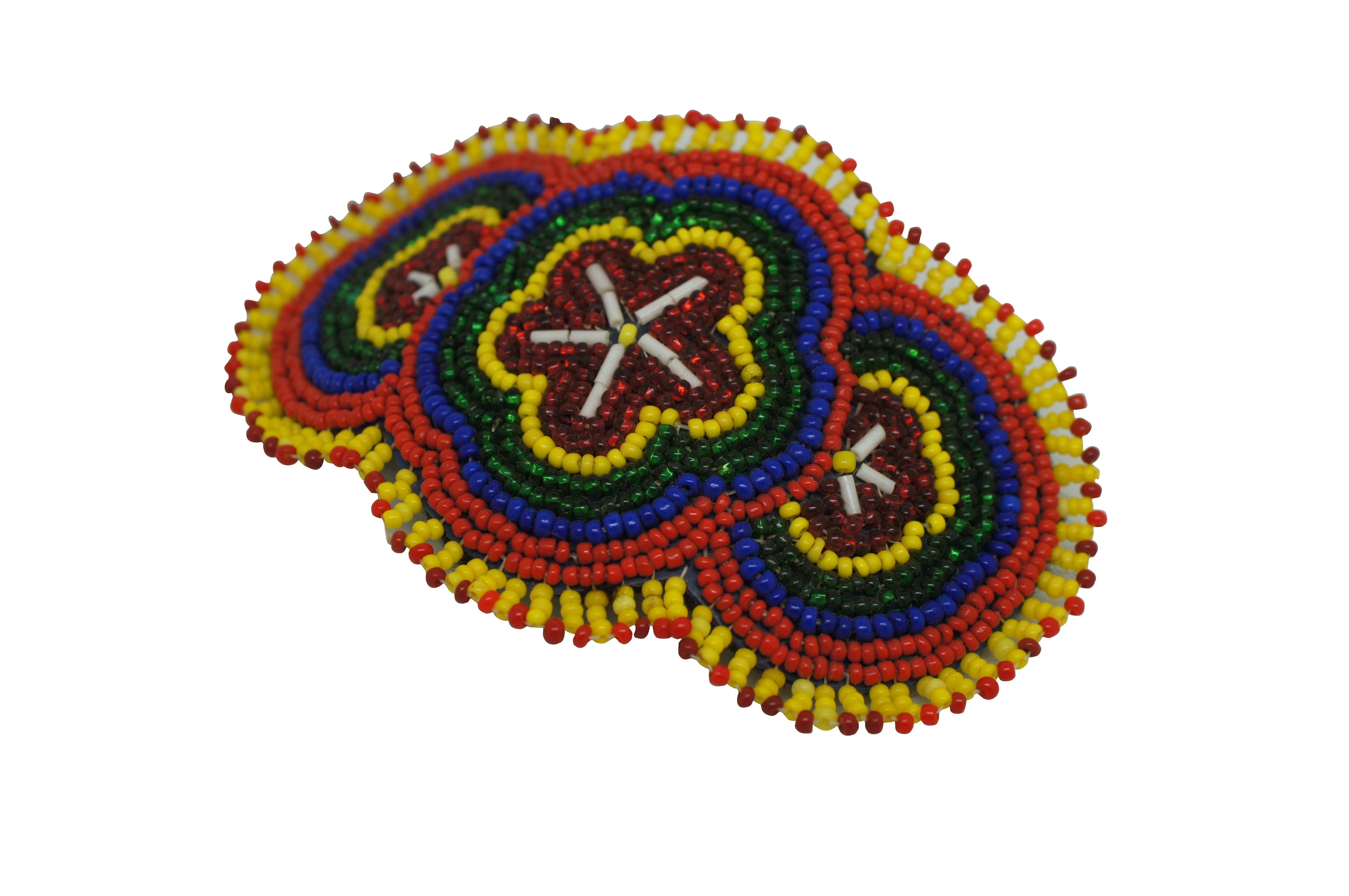 Vintage Native American / Navajo seed bead hair clip / bow / barrette featuring a colorful floral theme with white, red, yellow, green, and blue.  Purchased in the 1960s-1970s at Gilbert Ortegas Indian Arts, Gallup New Mexico.

Dimensions:
4.75