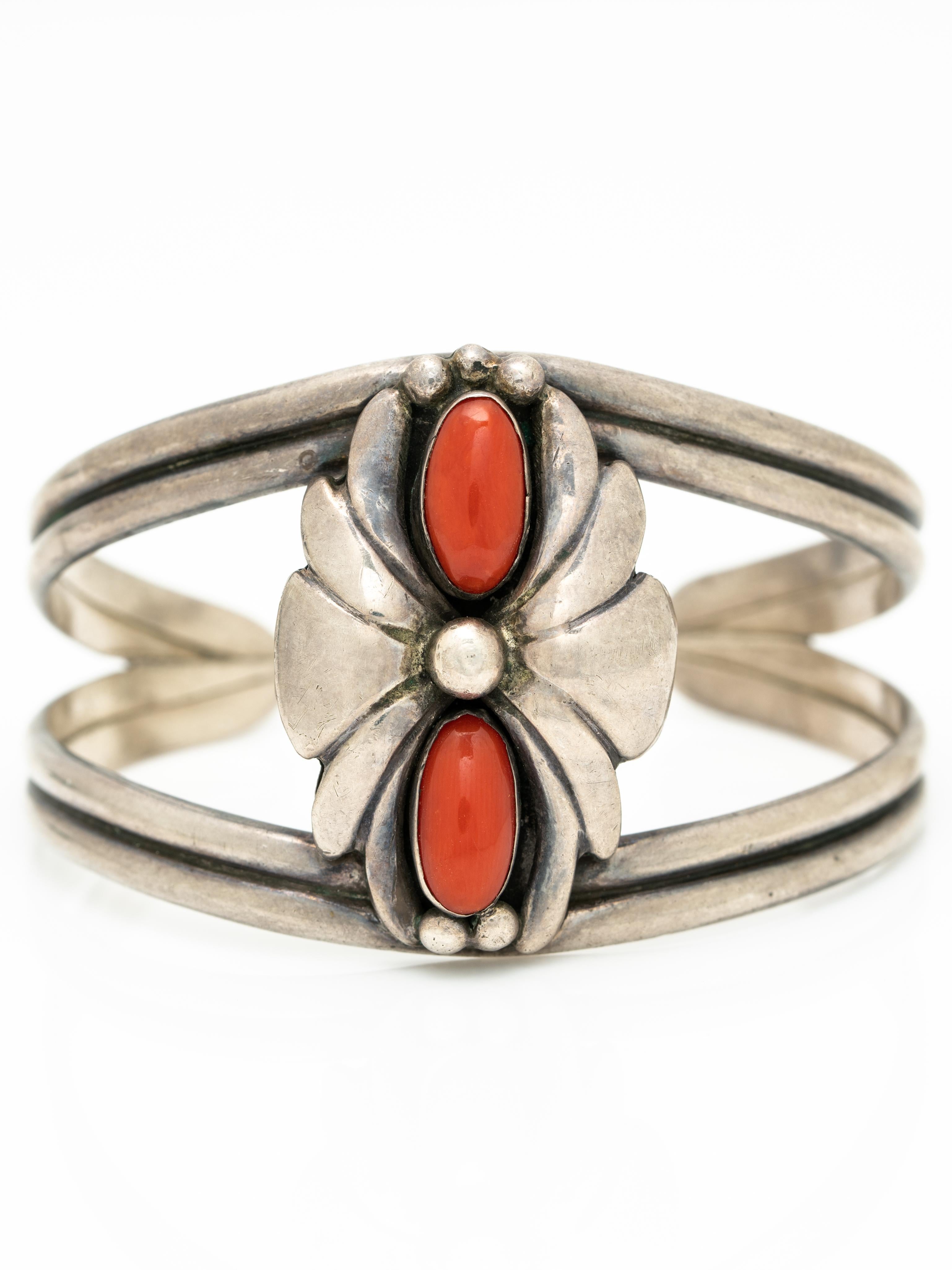 Vintage Native American Sterling Silver and Coral Navajo Cuff c. 1970s

The patina of the silver is oxidized, we do not clean vintage and antique silver pieces as some clients prefer these vintage treasures in their natural oxidized form but we are
