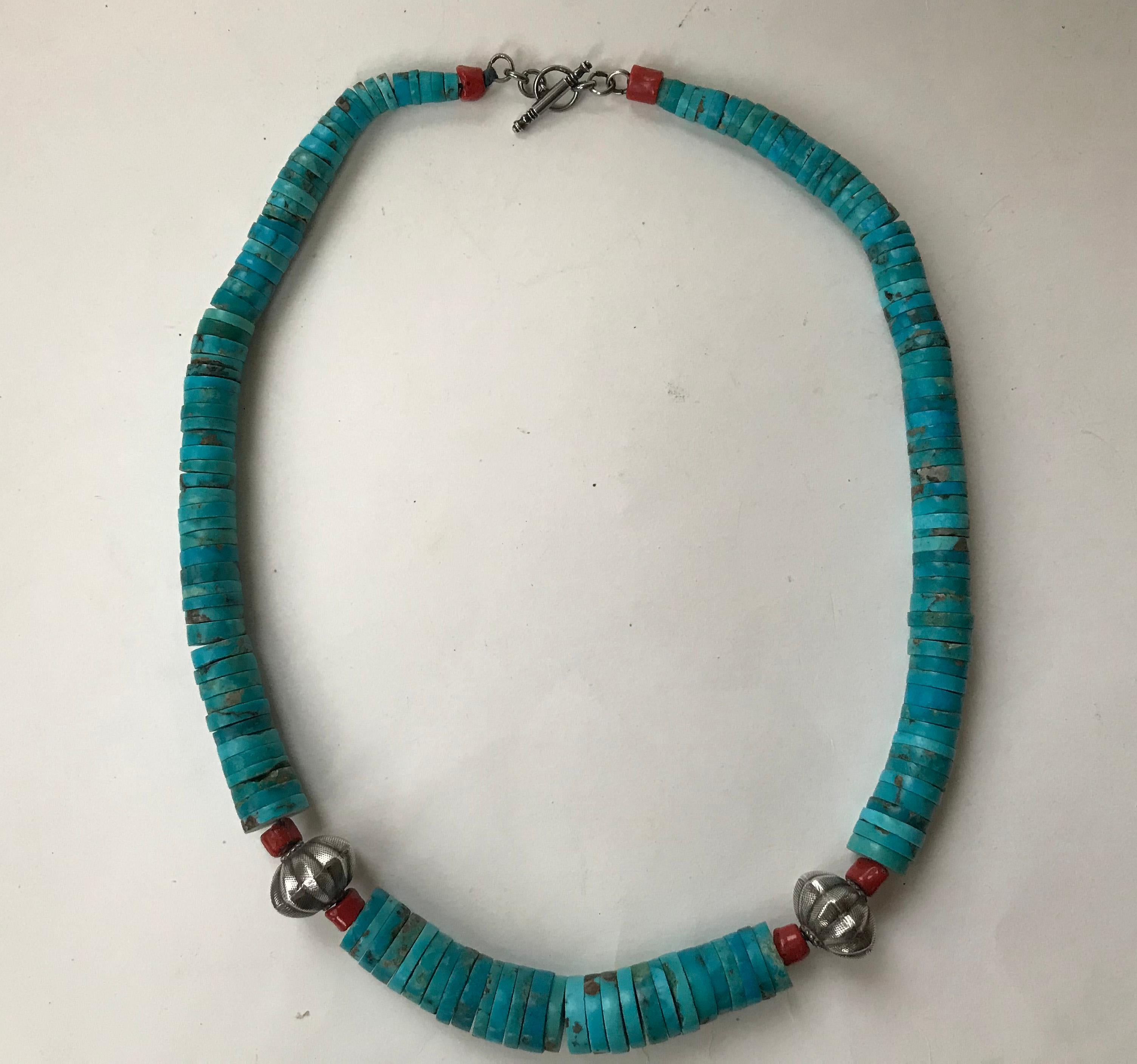 Native American style Artisan turquoise Coral & sterling Heishi Neckace.
Circa 1970`s.
Large graduated turquoise sliced stones with silver and coral beads.