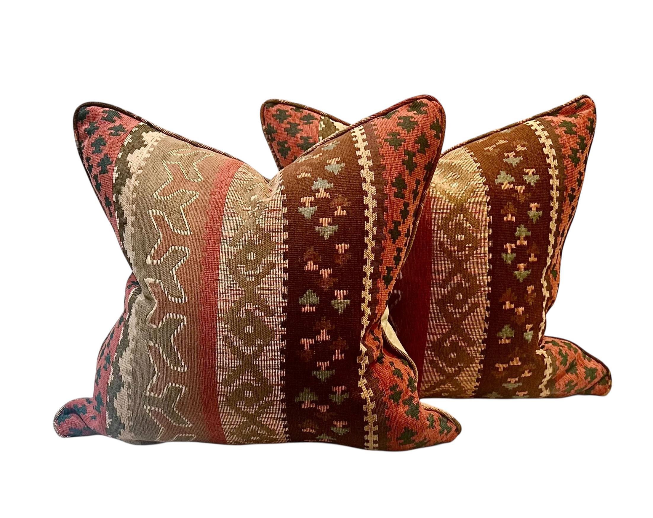A striking pair of vintage Native American weave pillows, crafted with timeless style and quality. The fronts feature a richly textured linen and cotton woven design, showcasing traditional geometric motifs and earthy tones. The backs are made of