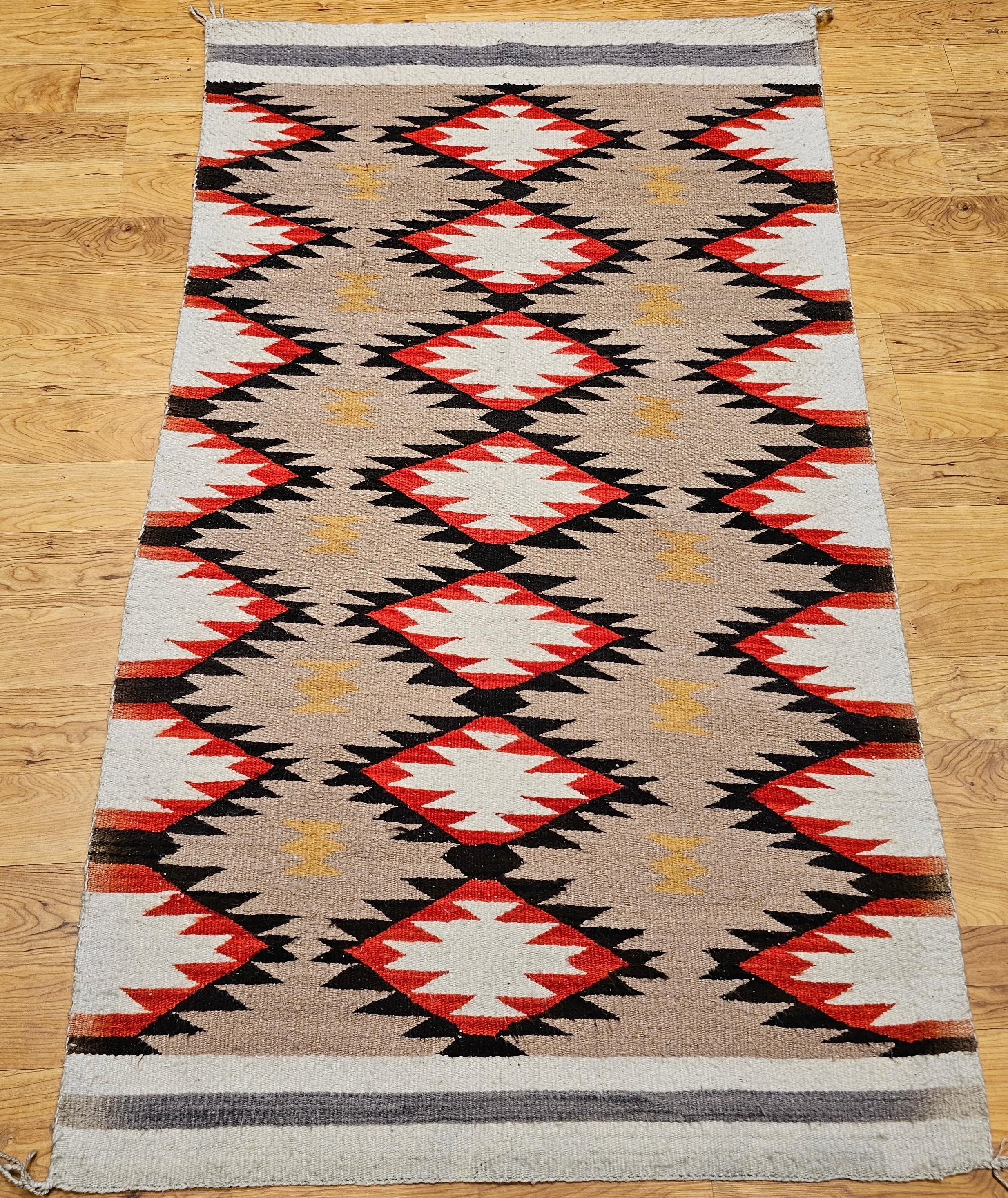 Bring timeless elegance and cultural heritage into your home with this vintage Native American Navajo area rug, featuring a classic Diamond pattern in a harmonious palette of ivory, brown, red, gray, and tan. Handwoven in the Southwestern United