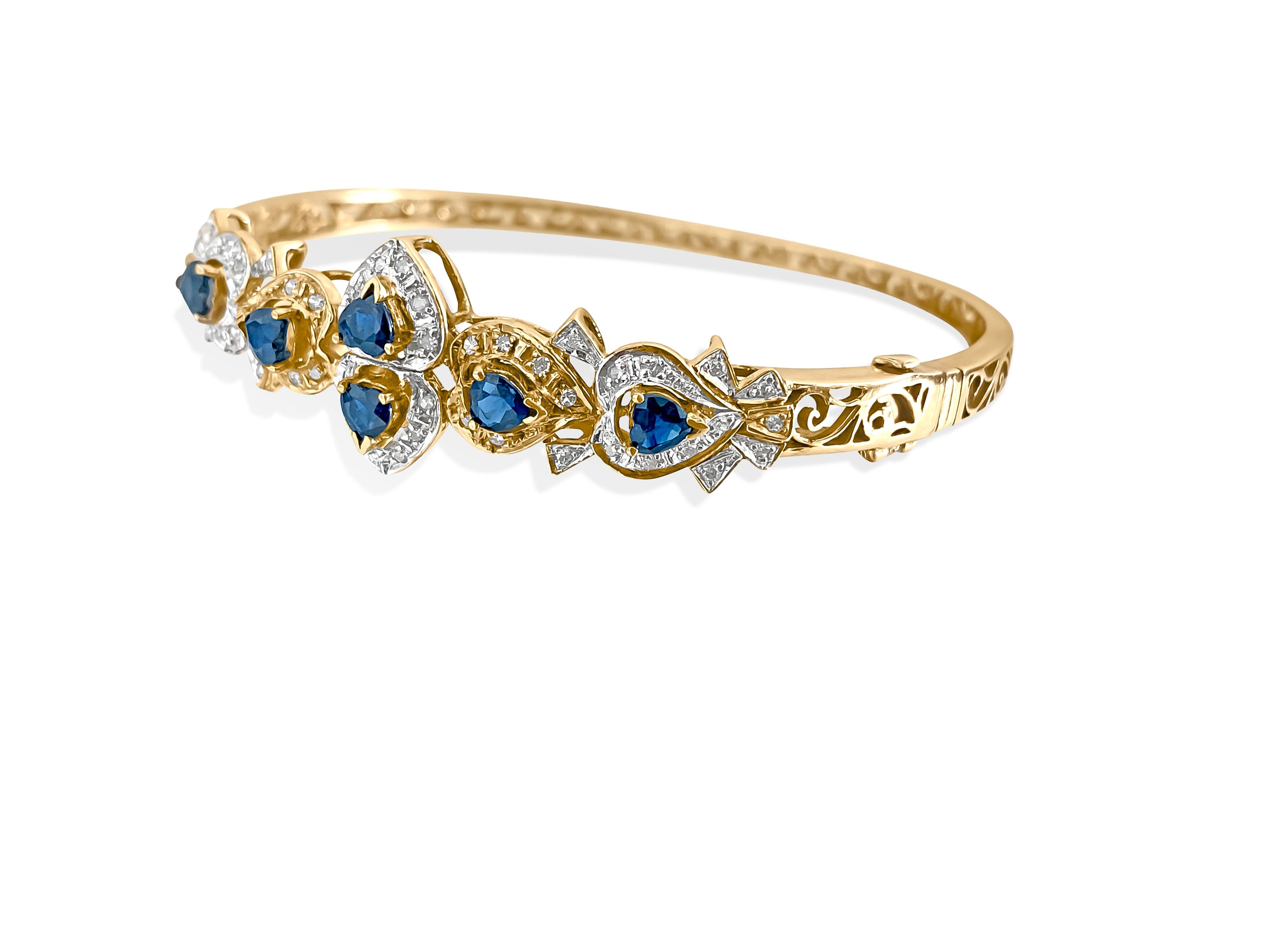 Metal: 14K yellow gold. 
2.00 ct blue sapphire total. 100% natural earth mined. Heart shaped blue sapphire. 

100% natural earth mined side diamonds. Round brilliant diamonds. Nice shine and luster. 
Handmade womens bracelet. Vintage style bracelet.