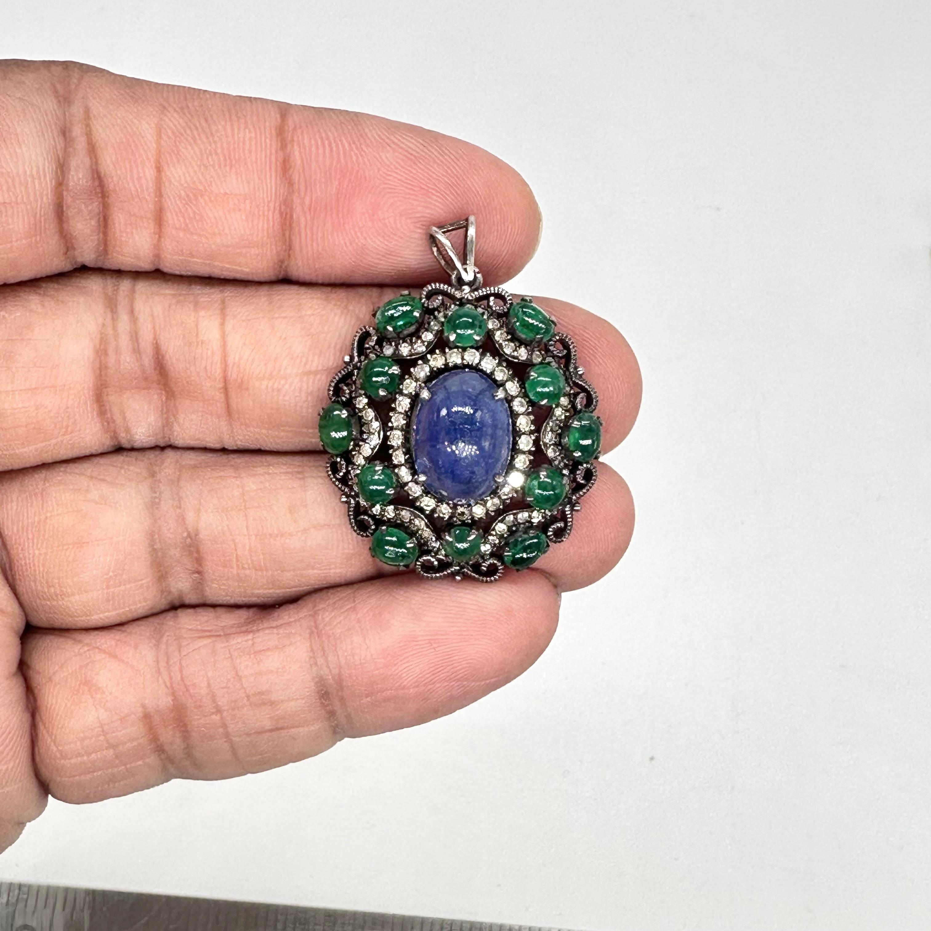 Questo splendido ciondolo è realizzato in argento ossidato con rari smeraldi cabochon e kyanite naturale. L'aspetto del ciondolo è impreziosito dai veri diamanti taglio brillante che vi sono accuratamente incastonati. È composto da argento sterling