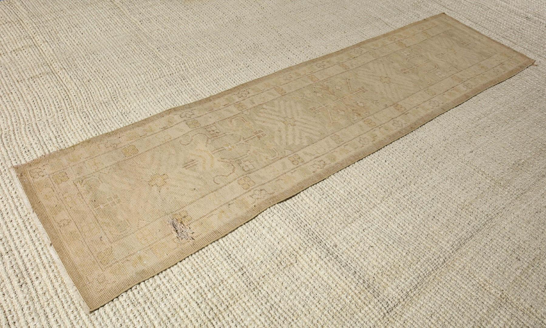 20th century natural, cream and beige toned Turkish Oushak runner. Short fringe on either end. One hole in the runner.