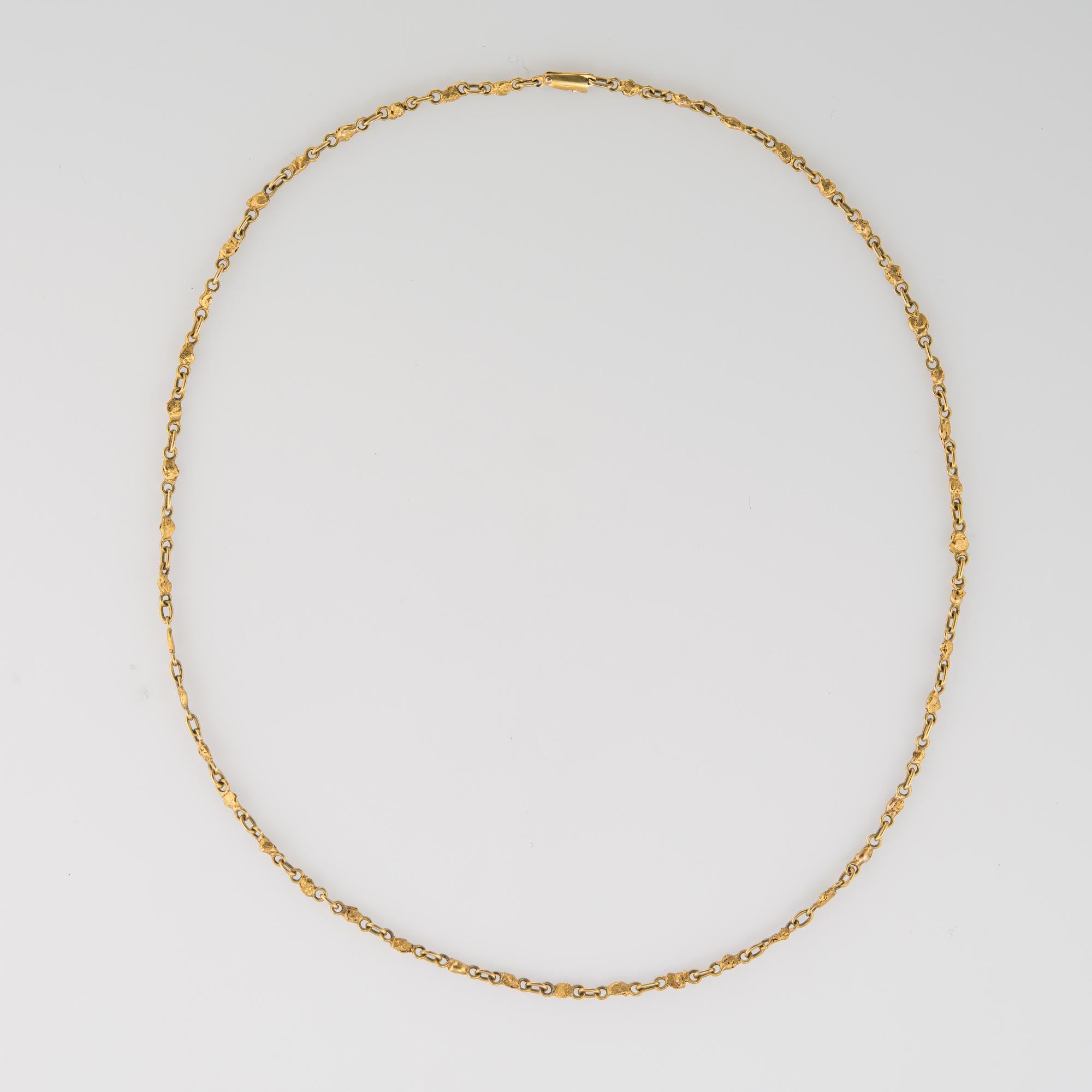 Stylish and finely detailed vintage nugget necklace (circa 1960s to 1970s), crafted in 14 karat yellow gold (chain) with 22k to 24k gold nuggets.  

The necklace measures 16 inches in length and sits nicely at the nape of the neck. The necklace