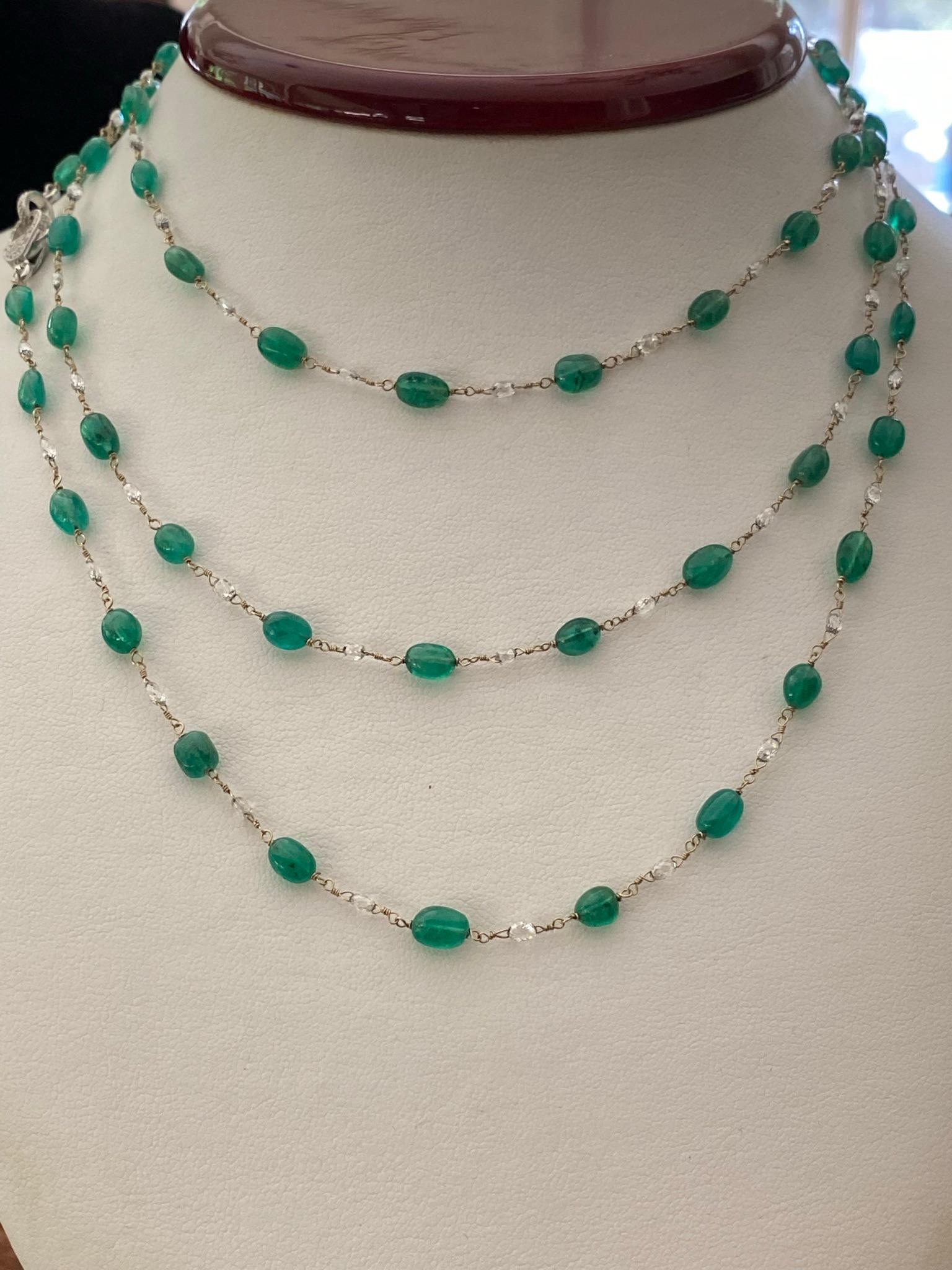 This magnificent vintage necklace is set with sixty-four natural green emeralds totaling 50.46 carats alternating between sixty-three naturally mined briolette-cut diamonds totaling 7.07 carats, GH color, VS-SI clarity. The necklace measures 48