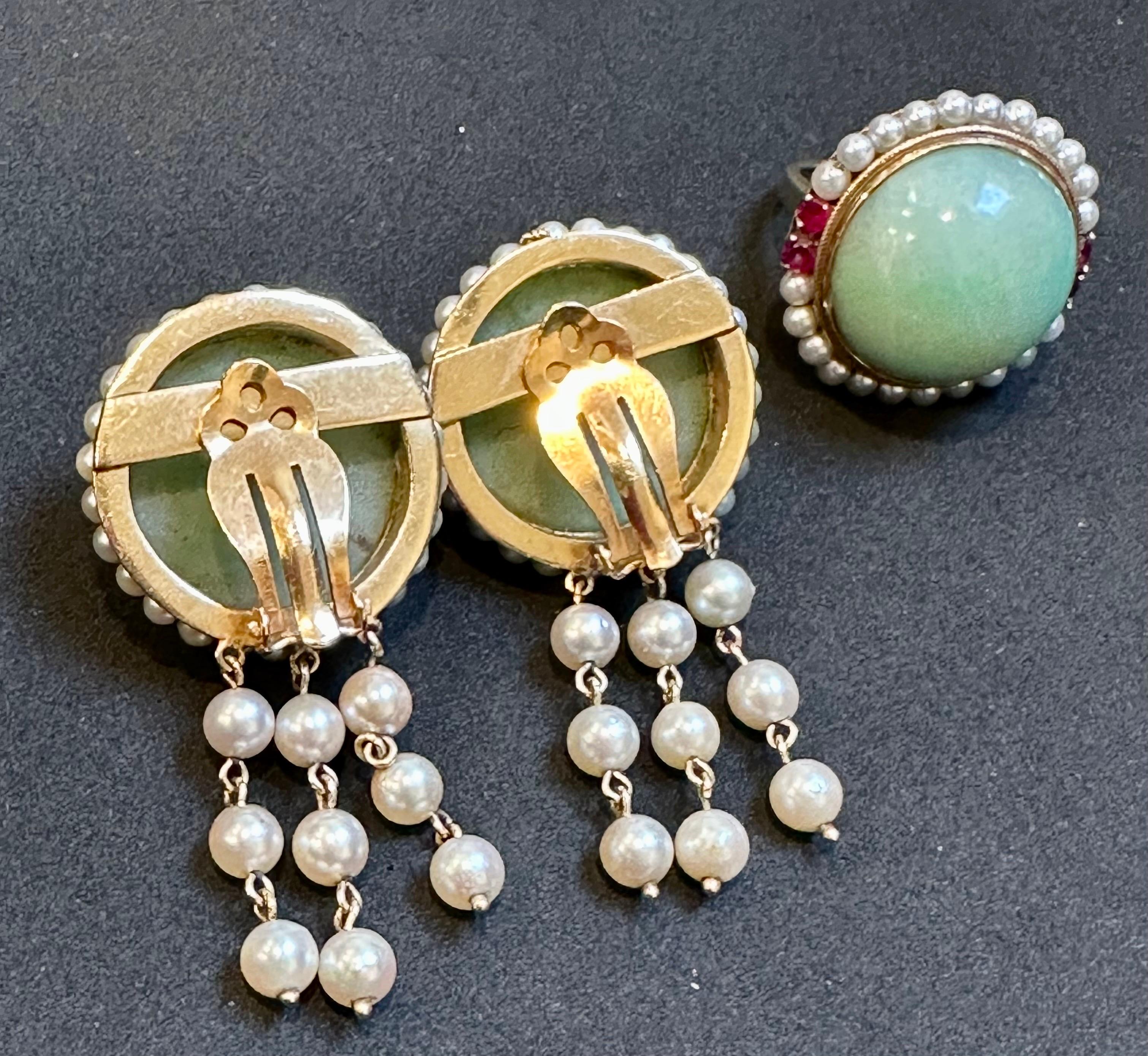 This Vintage Natural Jade Earring & Ring Set + Natural Pearls, 14 K Yellow Gold 48Gm is a stunning piece of jewelry that consists of approximately 60 Ct of Natural Jade with no treatment in the set of earring and ring. The jade stone is light in