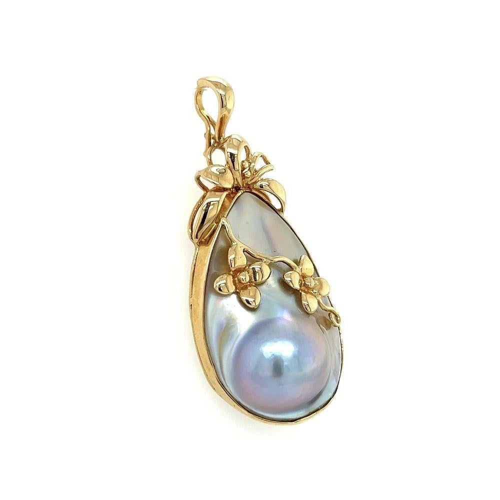 Simply Beautiful! Vintage Mabé Pearl Pear Shape Gold Enhancer Pendant. Beautifully Hand crafted in 18K Yellow Gold and accented with Gold designs. Measuring approx. 2”. More Beautiful in real time! Sure to be admired…A piece you’ll turn to time and