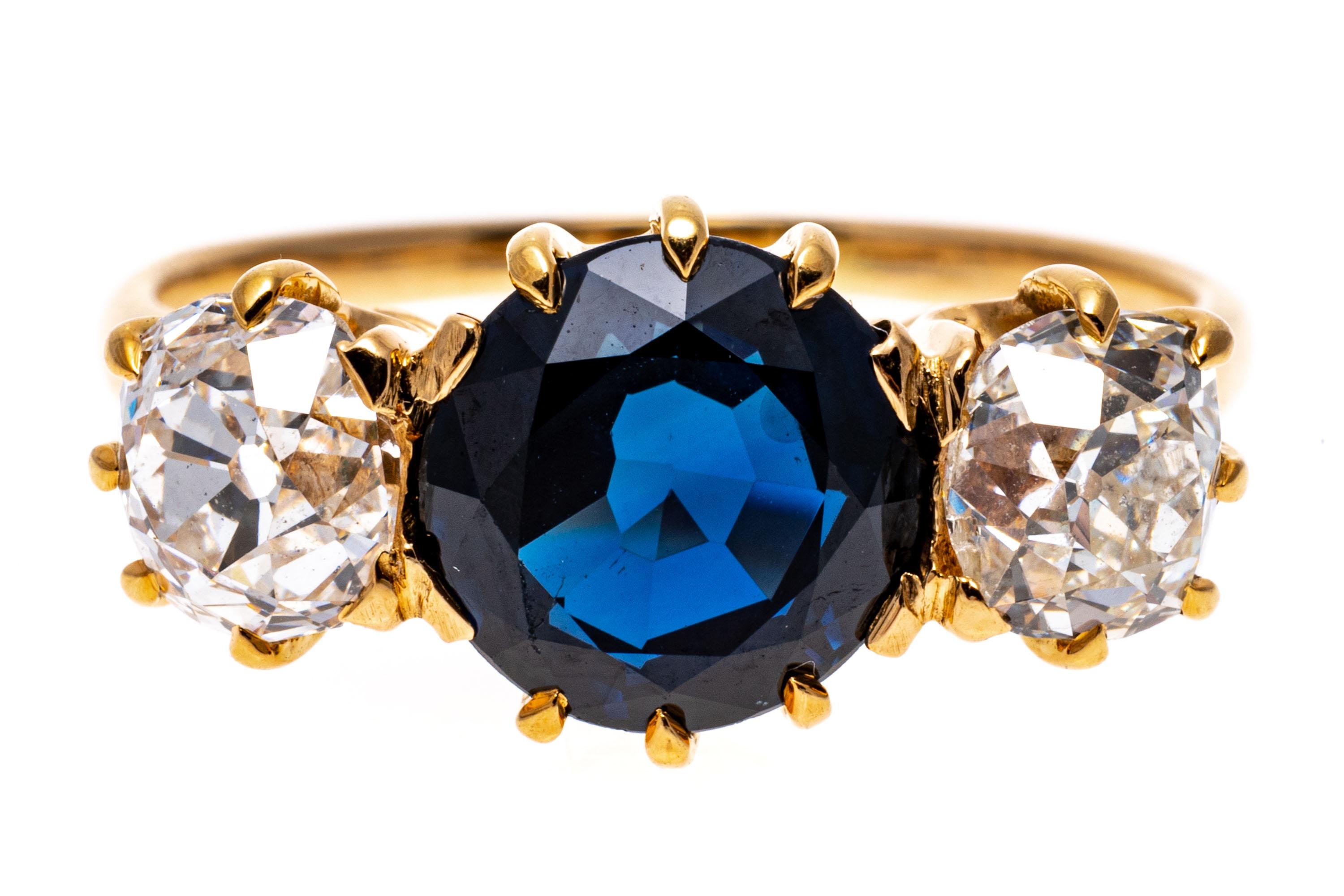 Vintage Natural No Heat Blue Sapphire And Old Mine Cut Diamond Ring. 
This beautiful, traditional vintage three stone ring has a magnificent round faceted, navy blue color sapphire center stone, 1.81 CTS, set with ten prongs, and GIA certed,