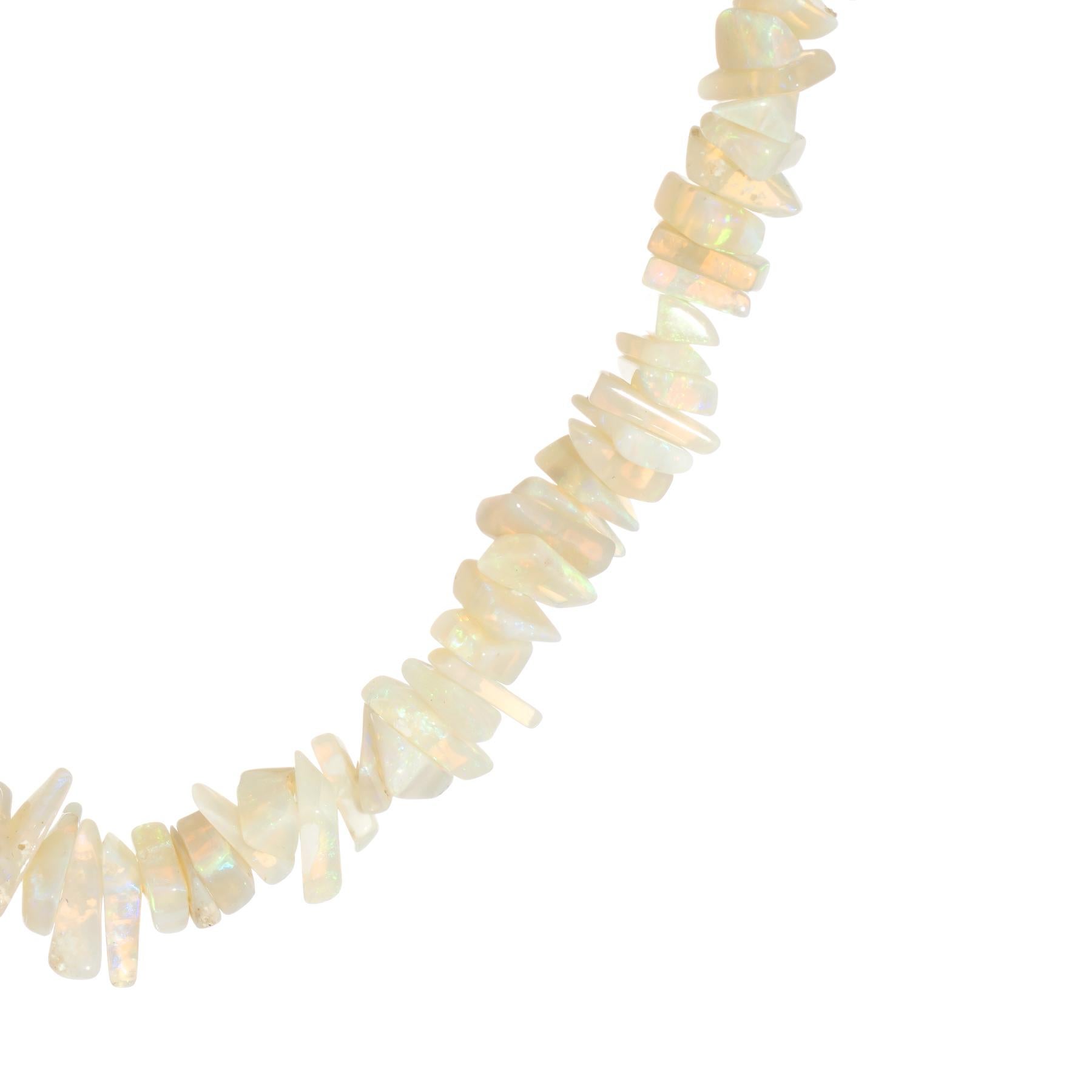 Elegant natural opal necklace, finished with a 14 karat yellow gold clasp.  

Natural opals are rough cut with a polished exterior surface. The opals measure from 5mm to 7mm. The opals exhibit a nice play of color from green to purple, turquoise,