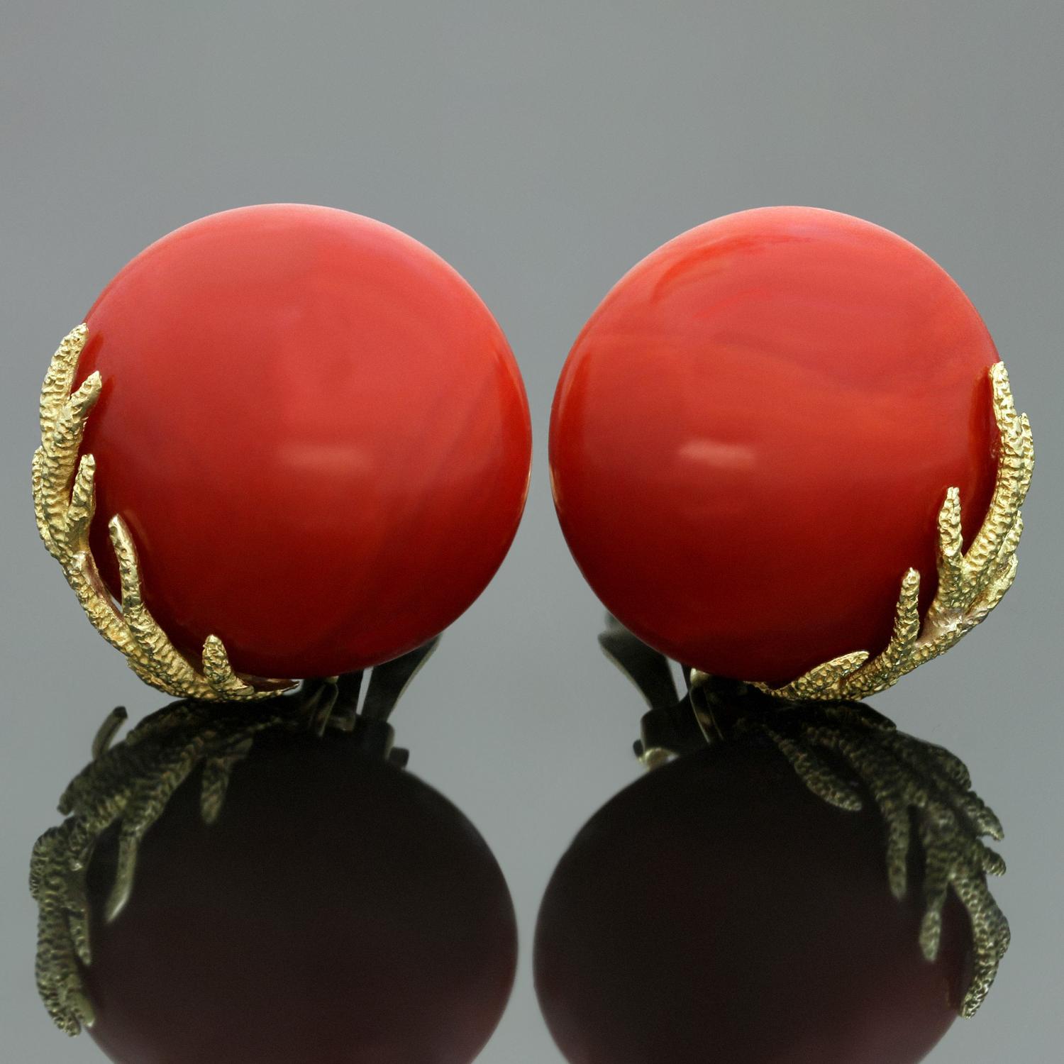 These stunning vintage clip-on earrings feature rouna natural oxblood corals with textured 18k yellow gold accents and 14k gold lever-backs. Made in United States circa 1960s. Measurements: 0.86