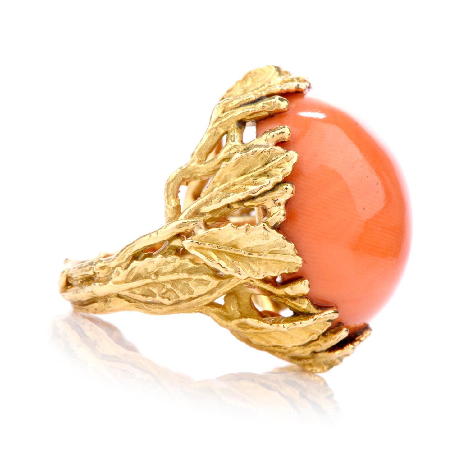 This ring boasts an opulent Peach colored Natural Salomon color Coral 

and crafted in 18K gold. 

Securing the large Coral are multiple leafed prongs and throughout

the shoulders.

Coral measures appx. 20.5mm in diameter.

Stamped 18K. 

Currently