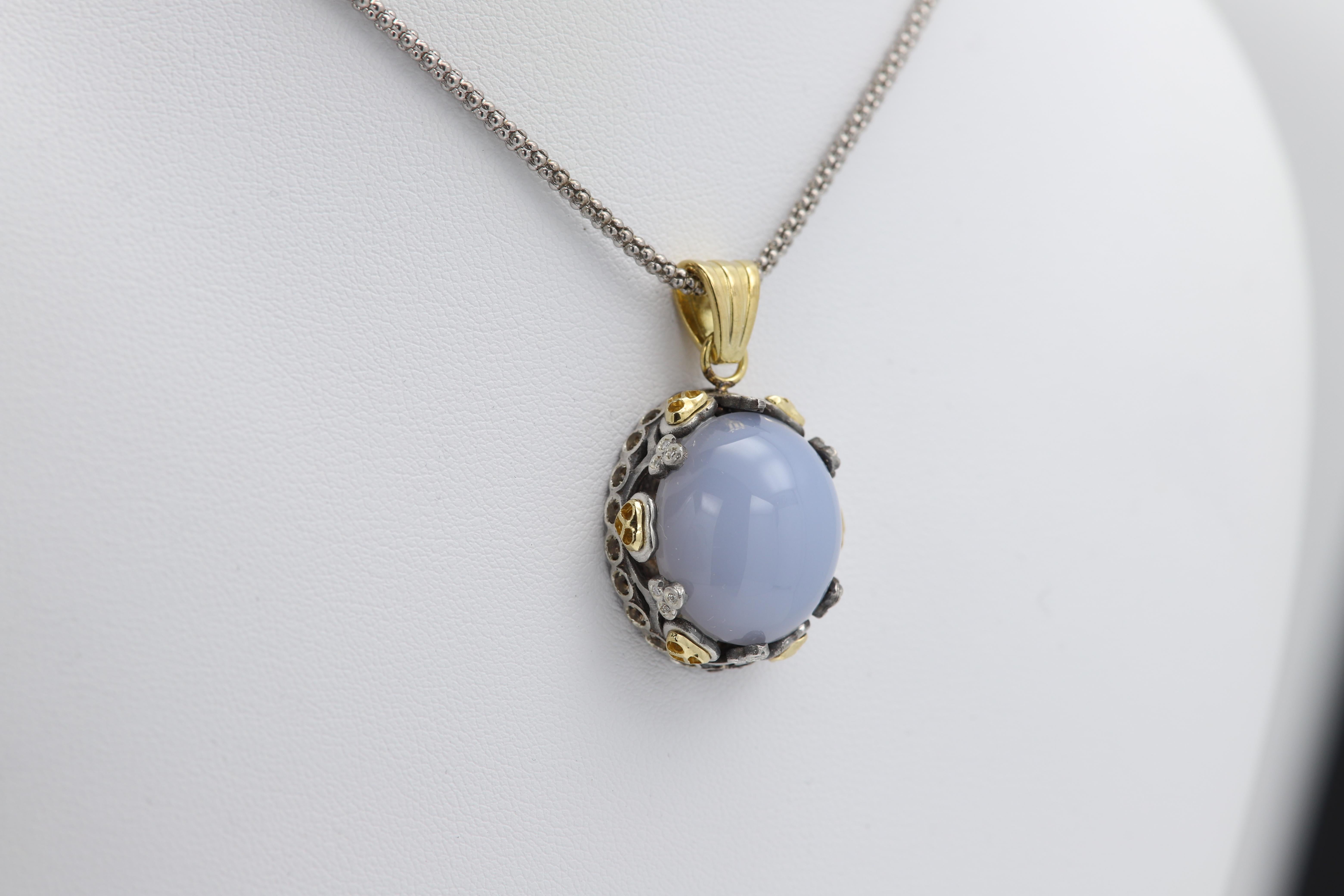 Brilliant Cabochon Natural Chalcedony
Vintage but never used.
Approx size 20 x 17 mm 
Has also real 18k ornaments on the sides.
Bail is silver plated gold.
and the rest most of it is Sterling Silver 925
Made in Italy.
Has also real natural diamonds