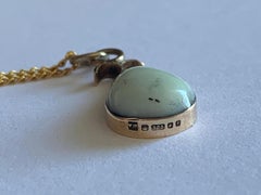9ct Gold Mounted Natural Stone Pendant with encased forget me not.